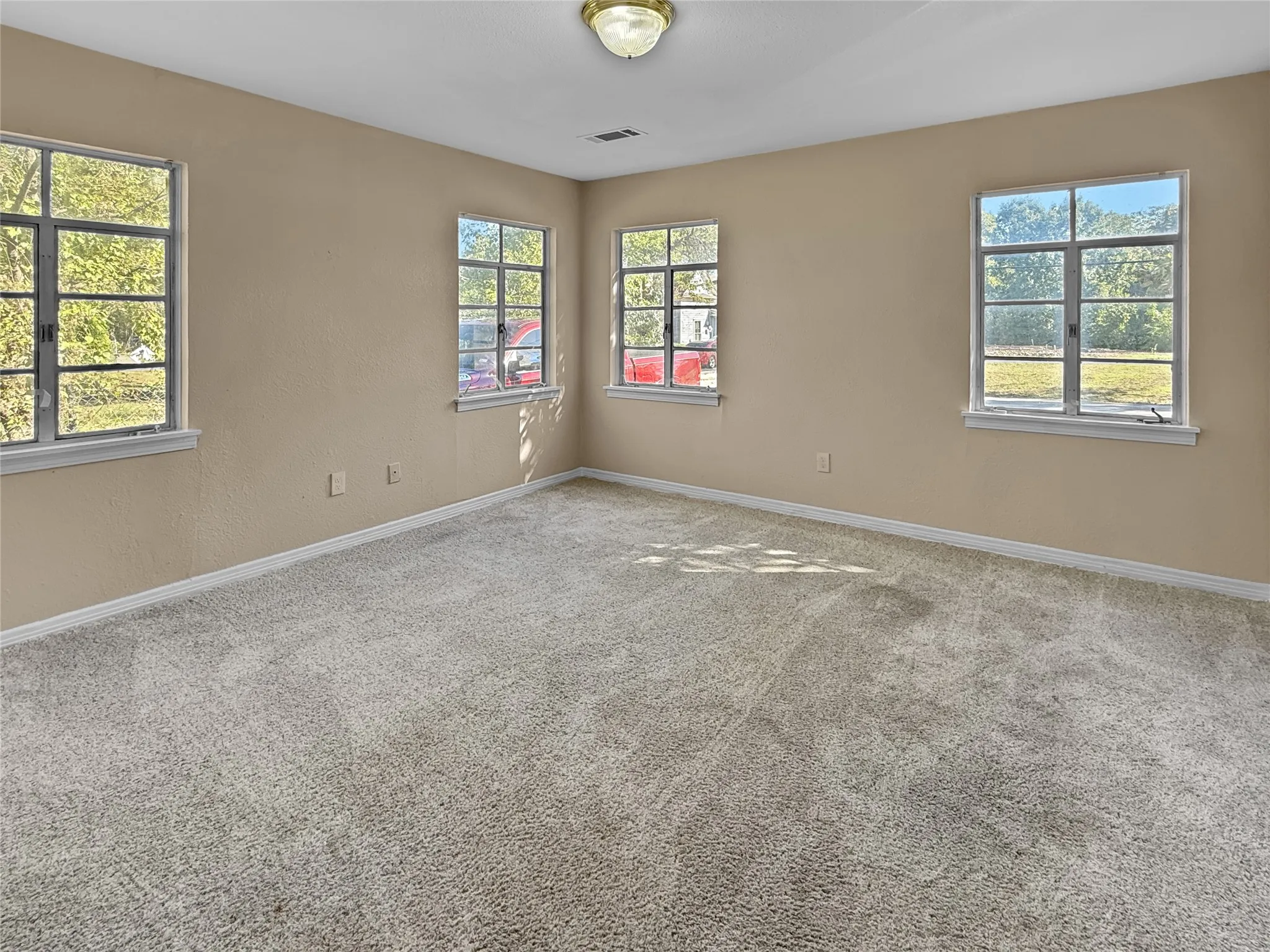 Neutral-toned walls complement plush carpet flooring