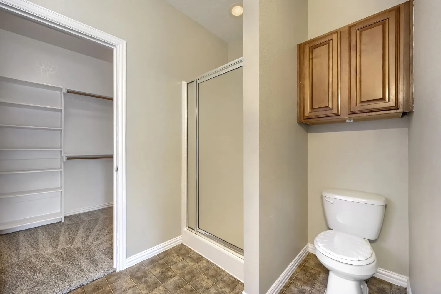 Walk-in closet with built-in shelving and hanging rods