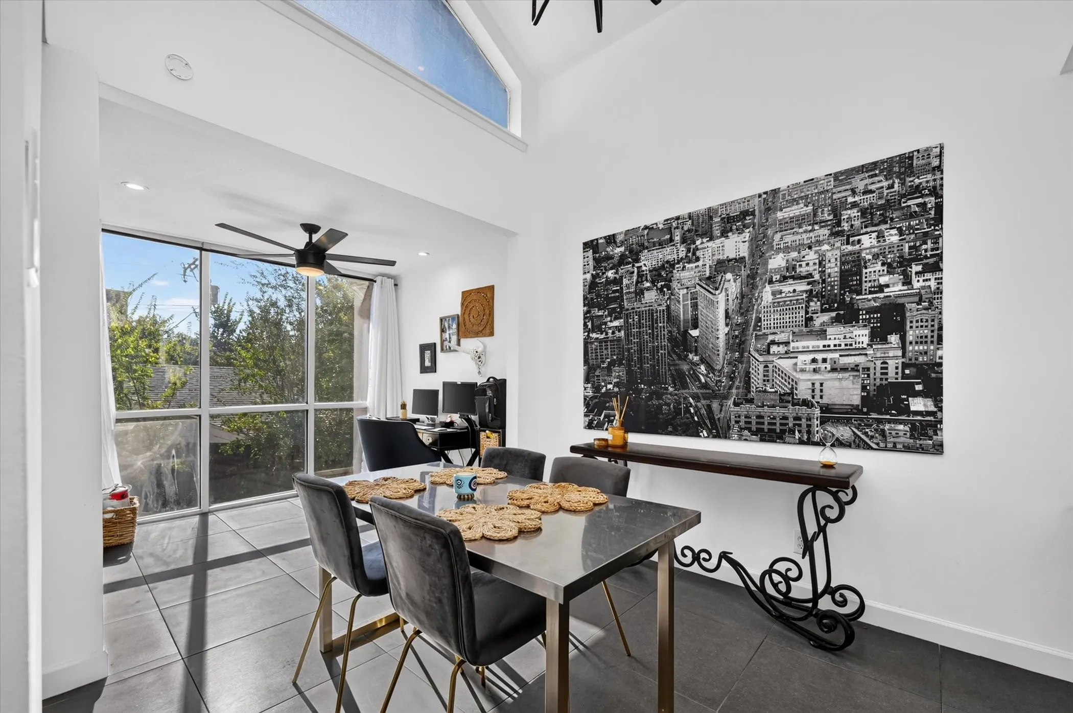 Vaulted ceiling, full-height windows, transom window, recessed lighting, and dark tile flooring
