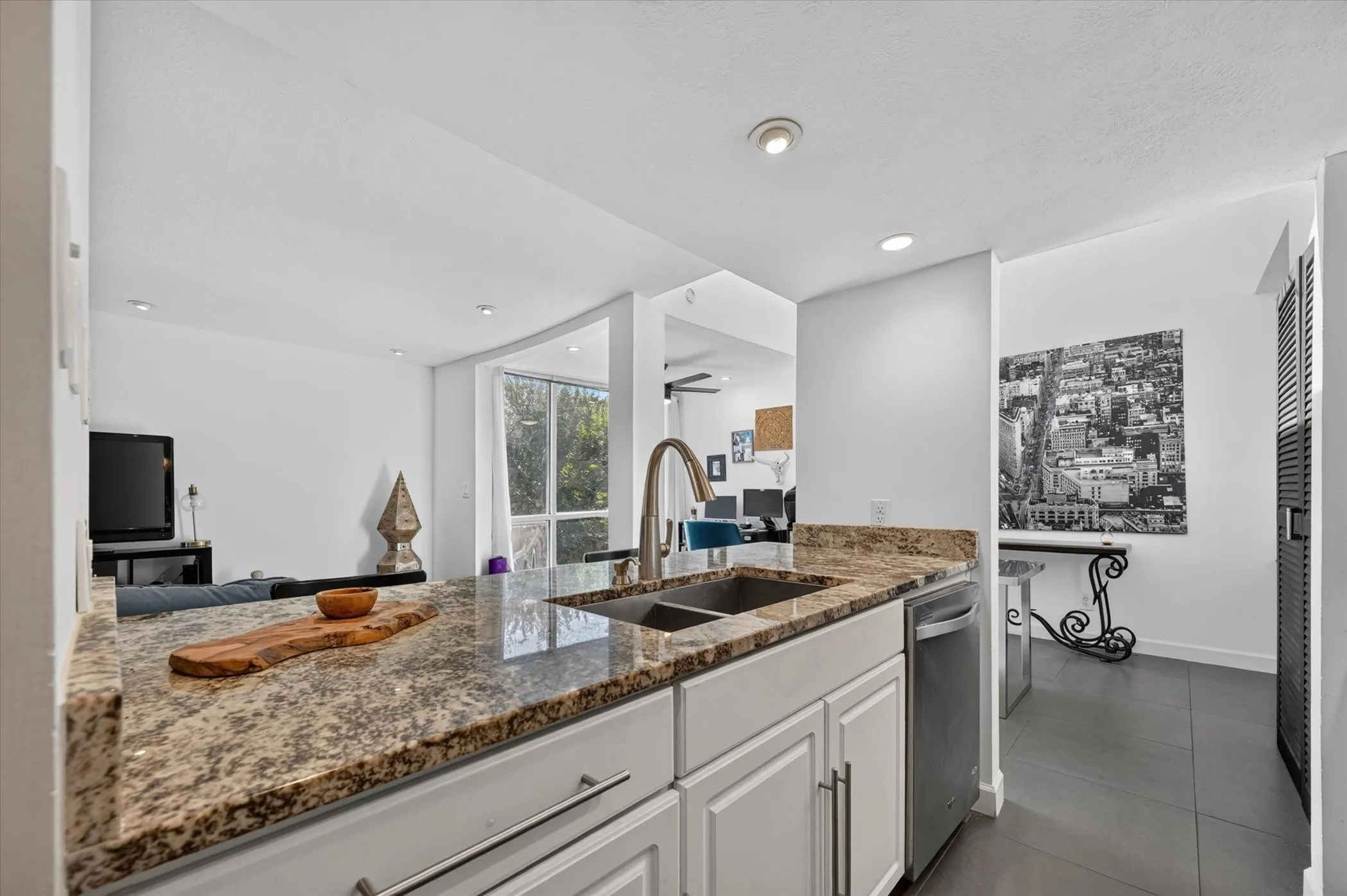 Granite countertops, white cabinetry, dual basin stainless steel sink, and stainless steel dishwasher