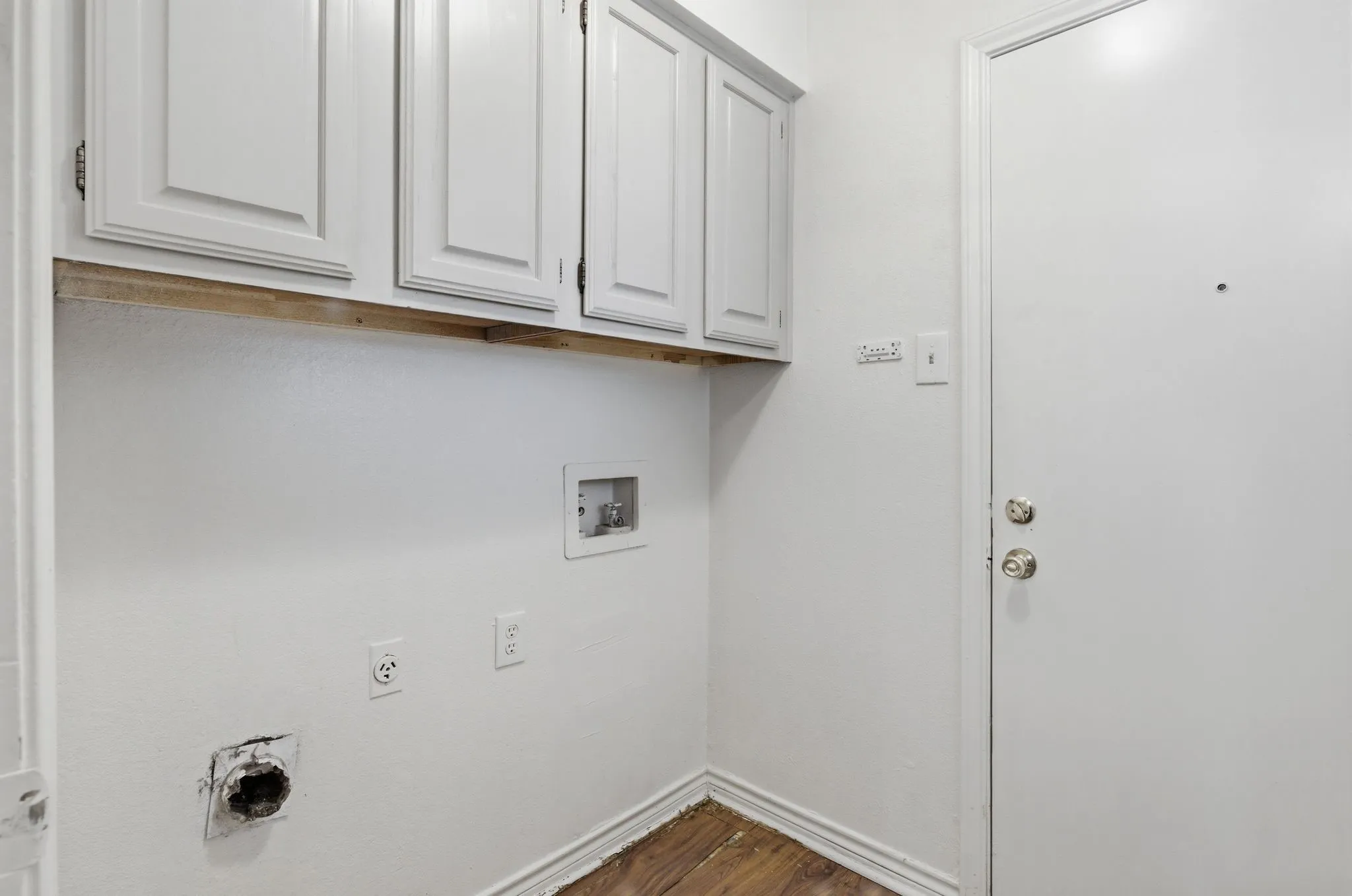 White shaker-style upper cabinetry with brushed nickel hardware