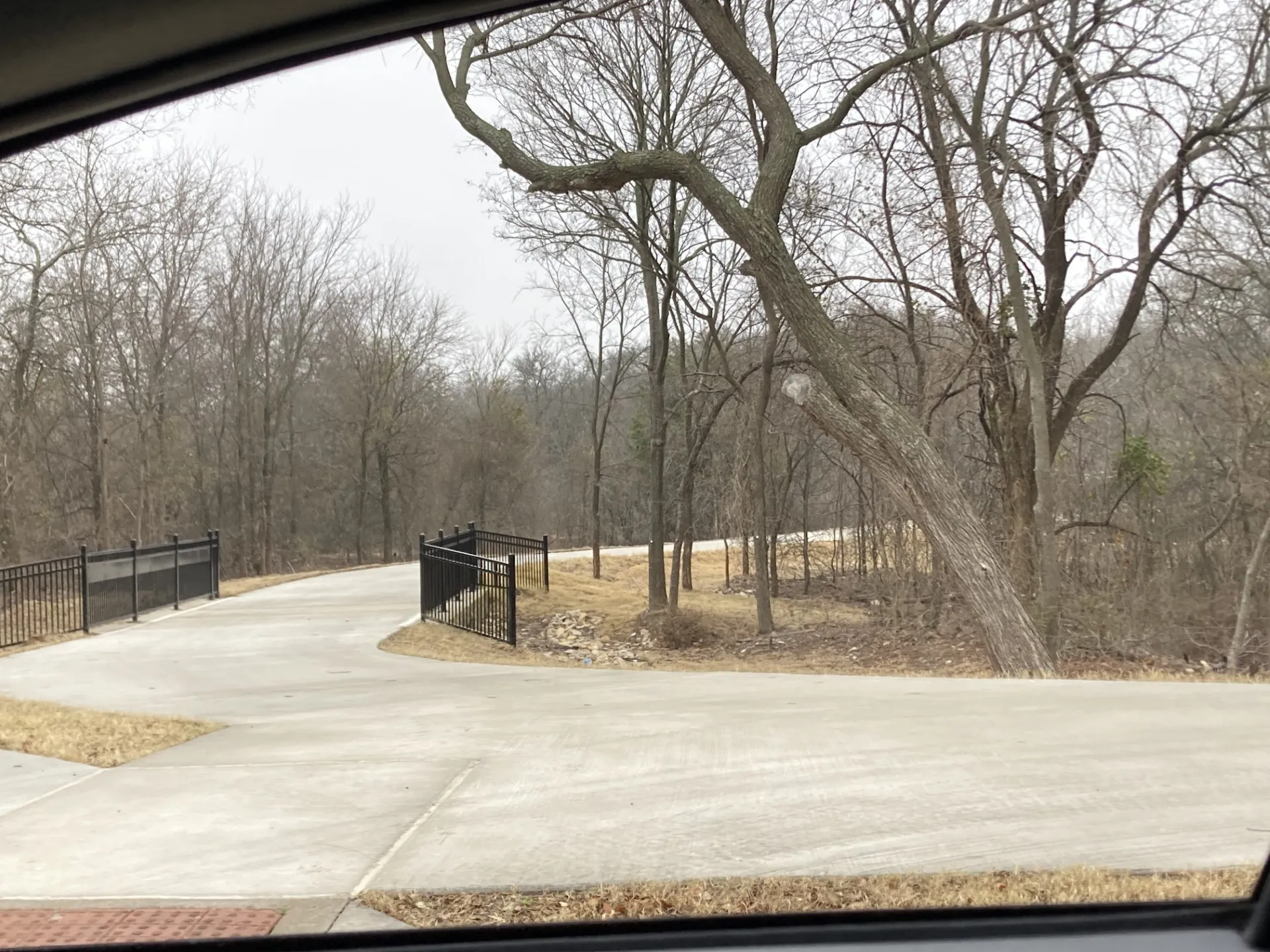 Concrete drive with black metal railing
