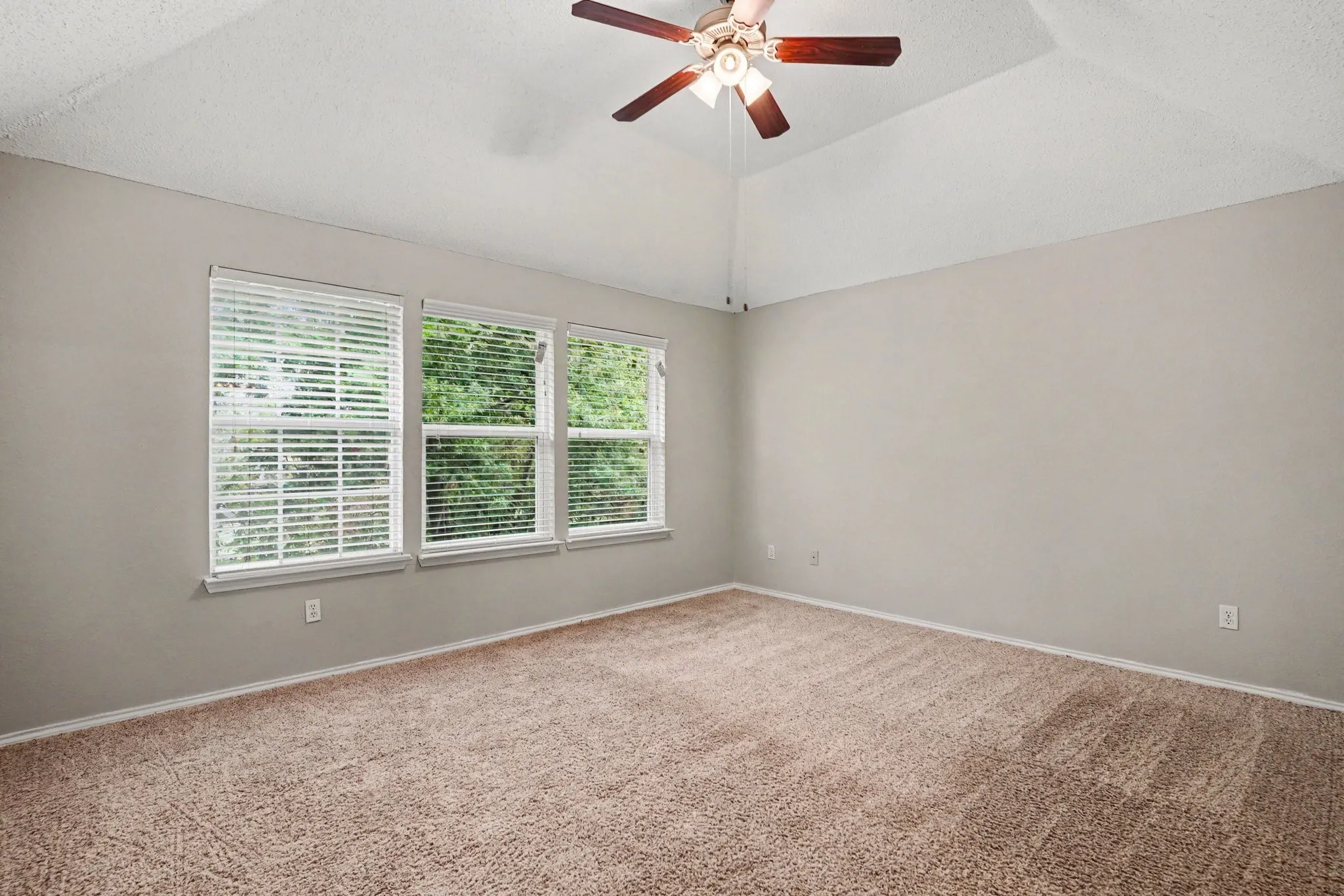 2nd floor: Primary bedroom with vaulted ceiling, large windows offering plenty of natural light.