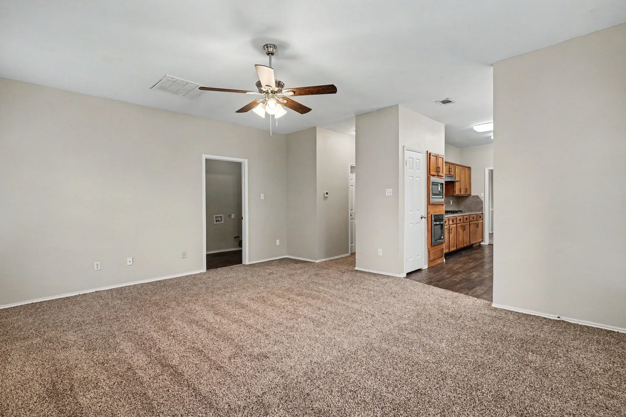 View from family room into the kitchen and access to the laundry room and garage