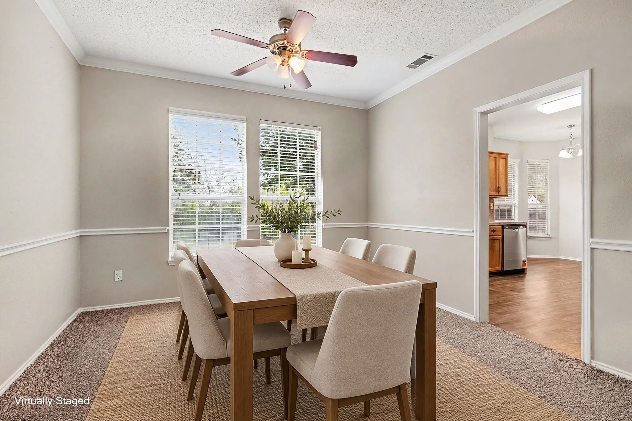 View into the virtually staged formal dining room. Opened to the living room
