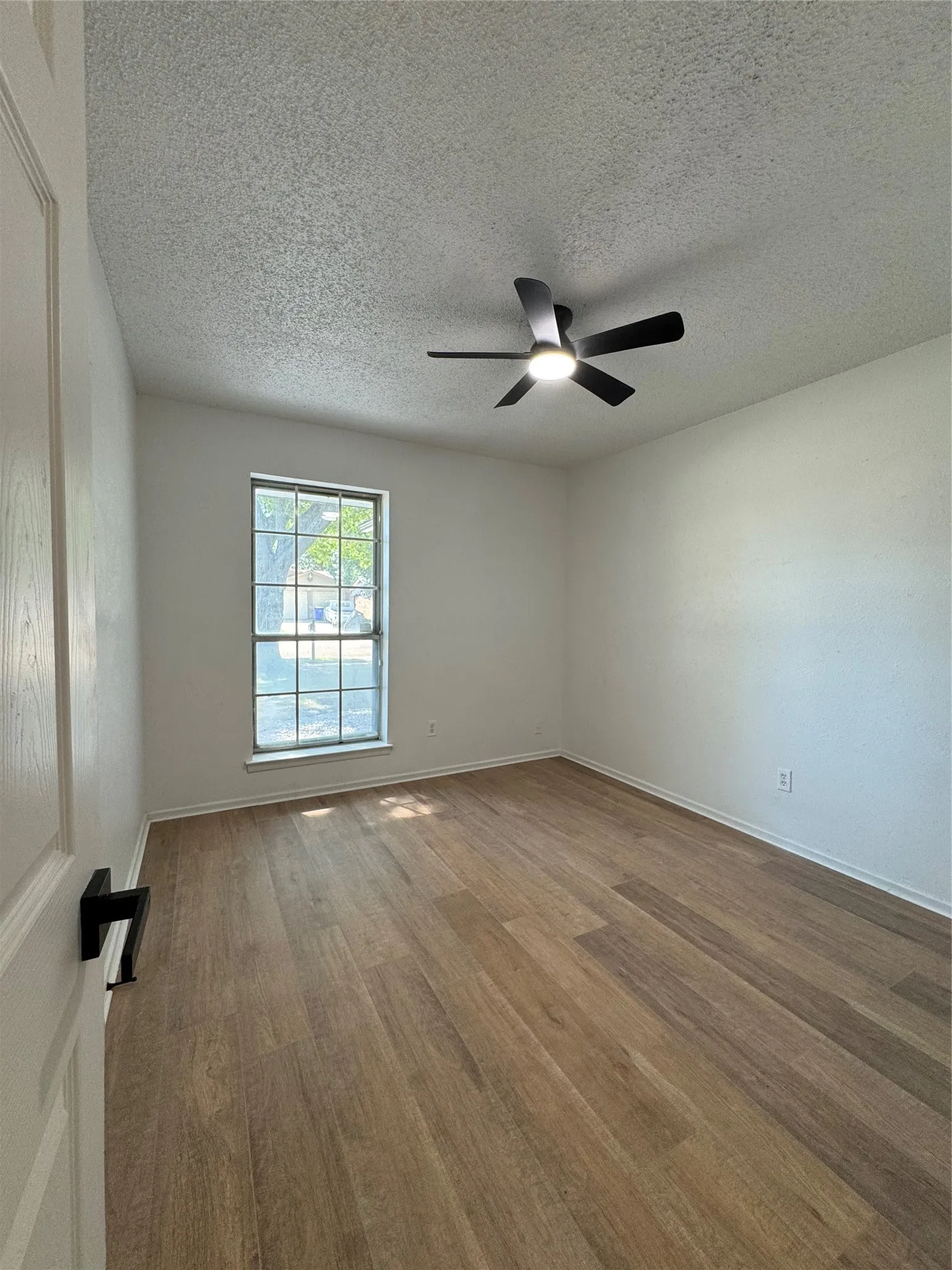 Wood-finish flooring with white walls and trim