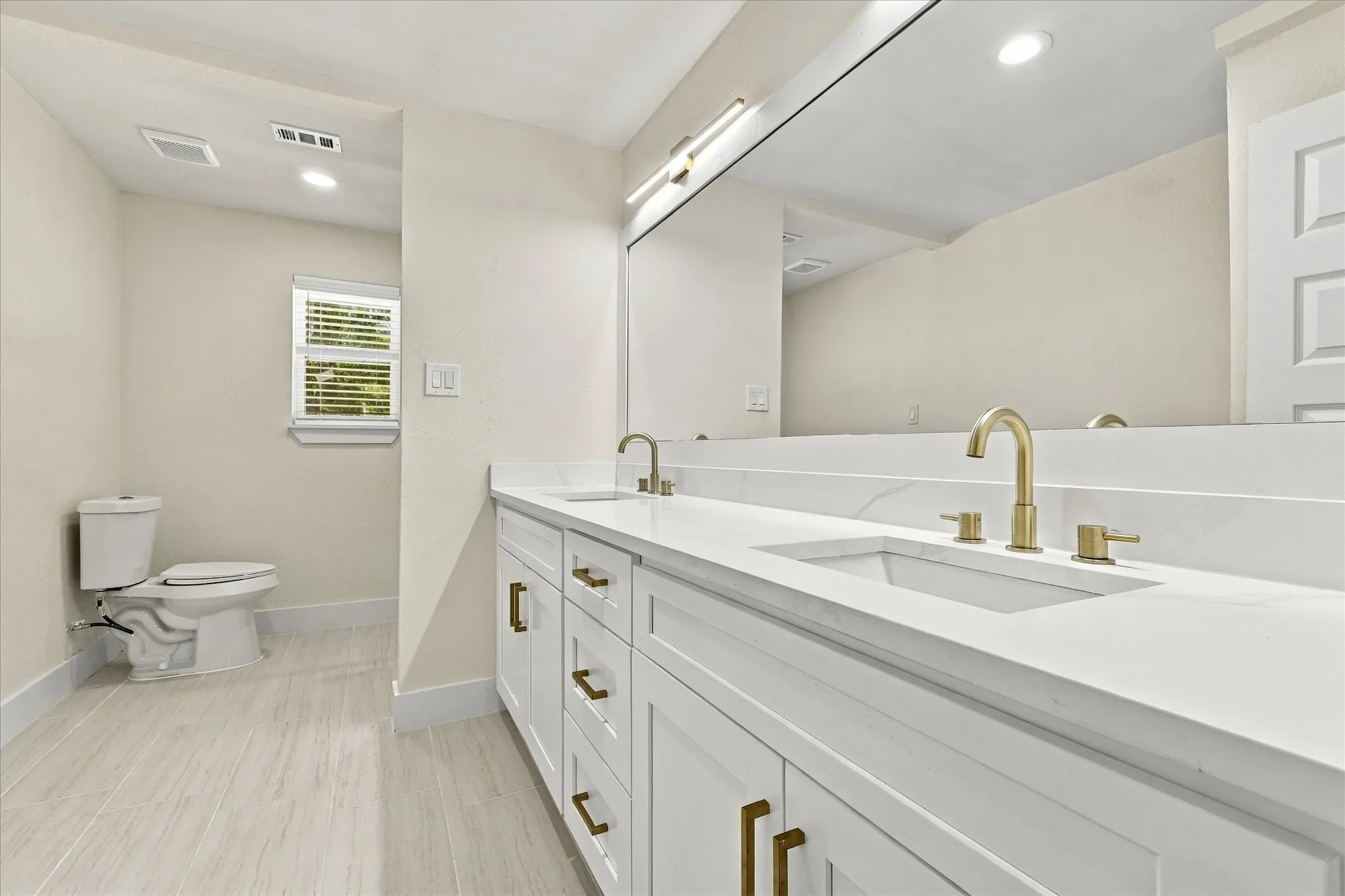 Plush carpeting, recessed lighting, and a contemporary ceiling fan with integrated lighting