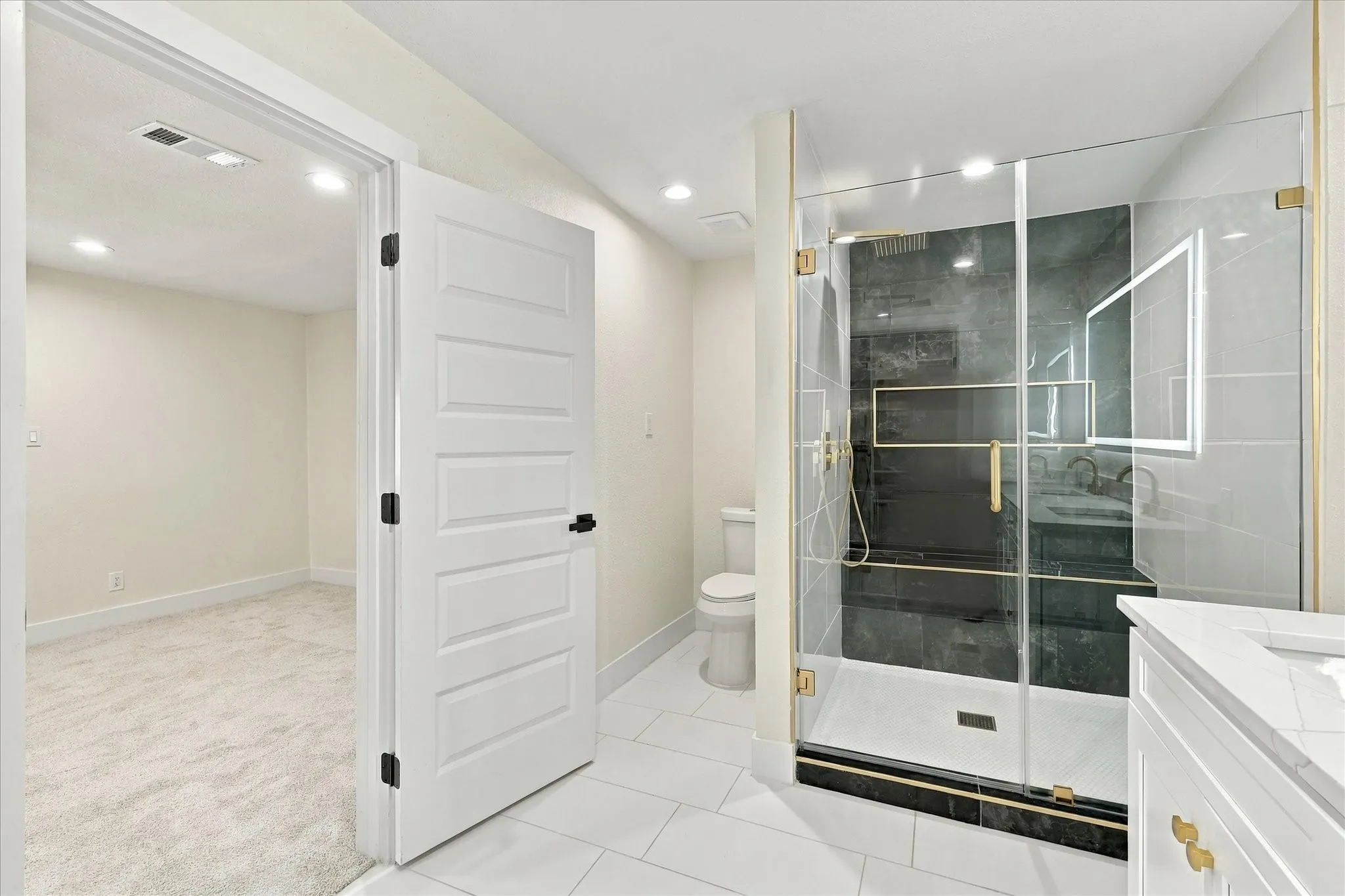 Walk-in closet featuring built-in shelving, two levels of hanging rods, and light-toned carpeting