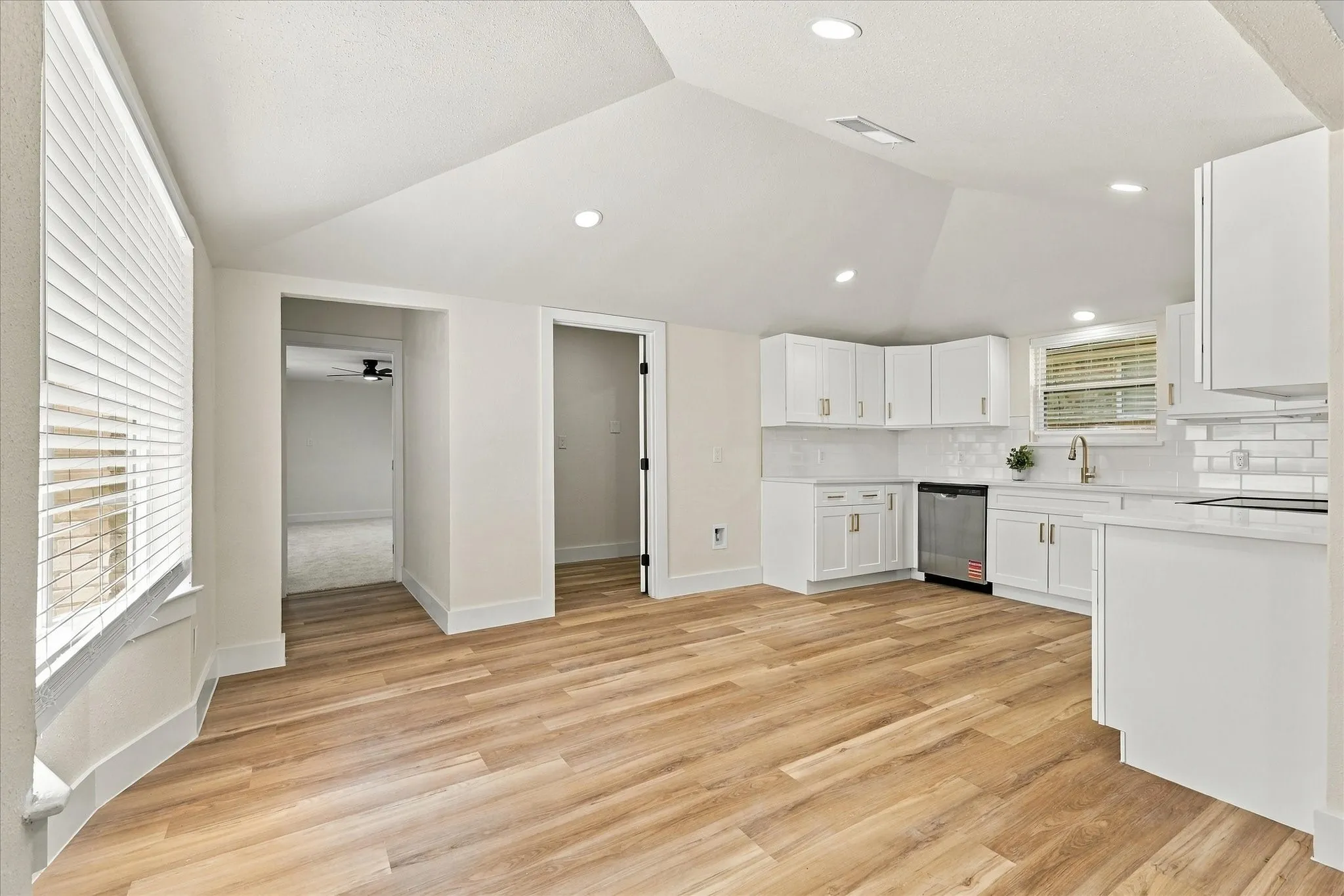Recessed lighting, ceiling fan, carpeting, two windows with blinds, and a paneled​​‌​​​​‌​​‌‌​‌‌​​​‌‌​‌​‌​‌​​​‌​​ door