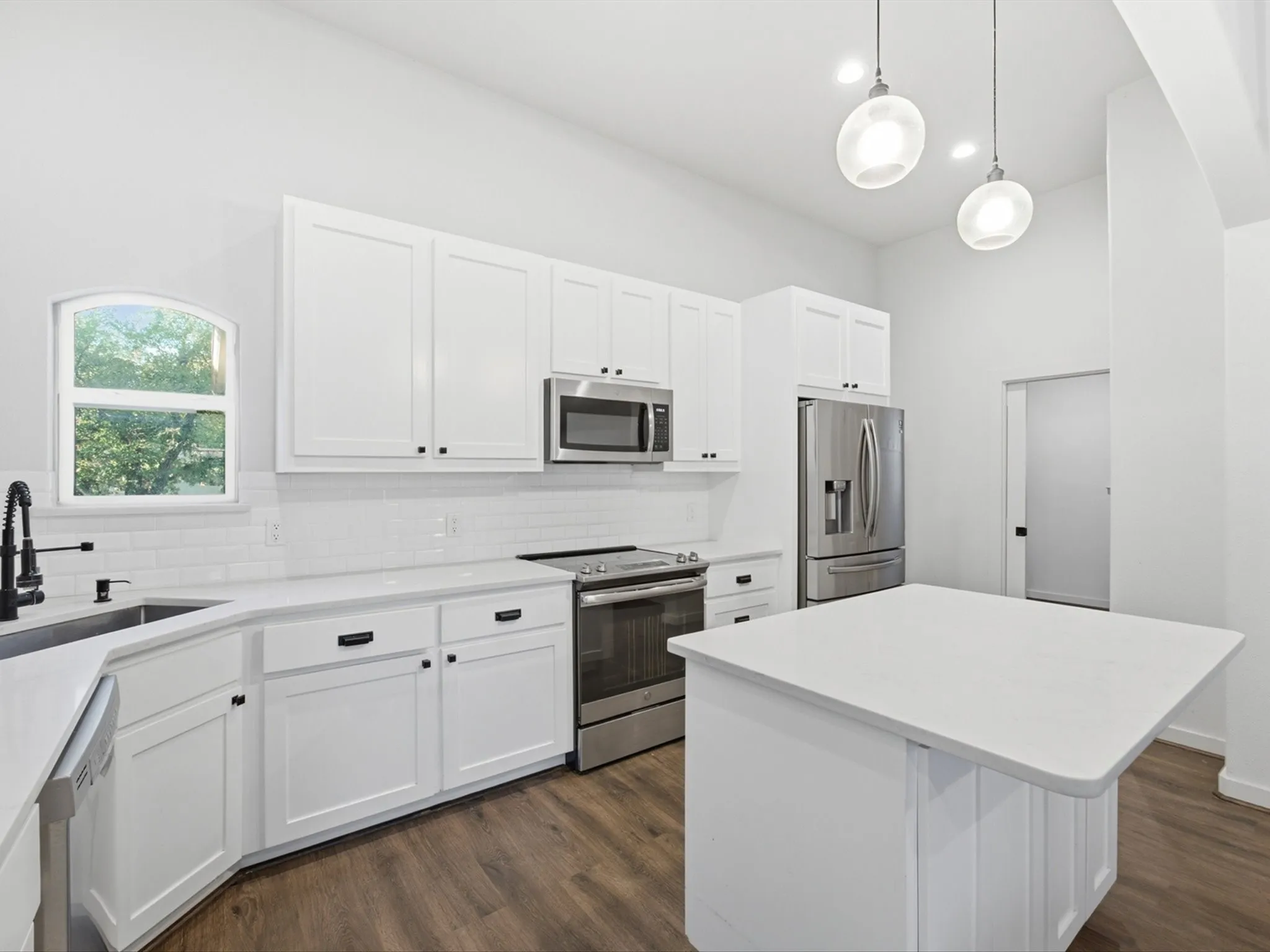 you can see the laundry room door from this view- it is not a garage passthrough but its own seperate space