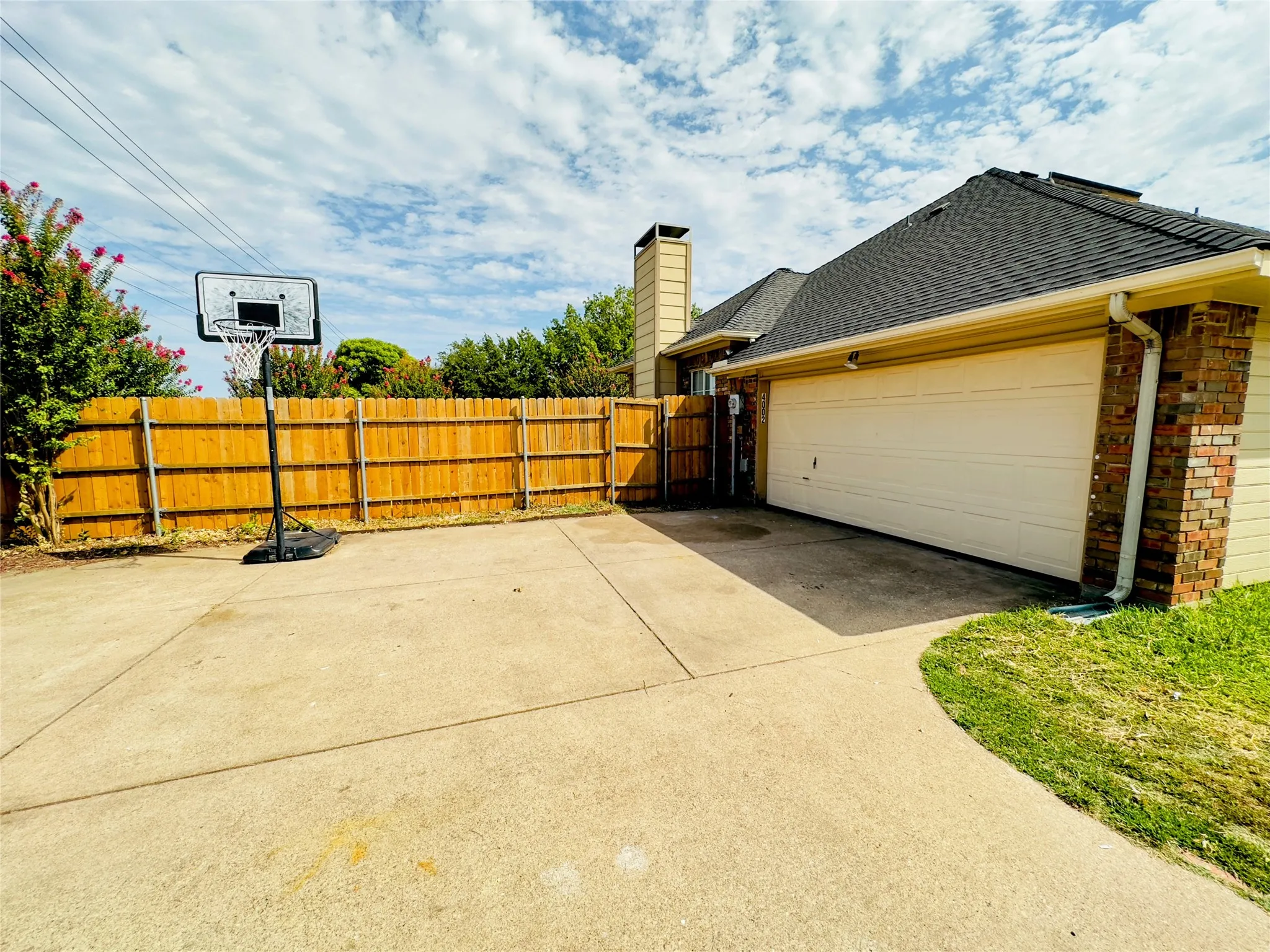 Concrete driveway leading to a two-car garage with a single door