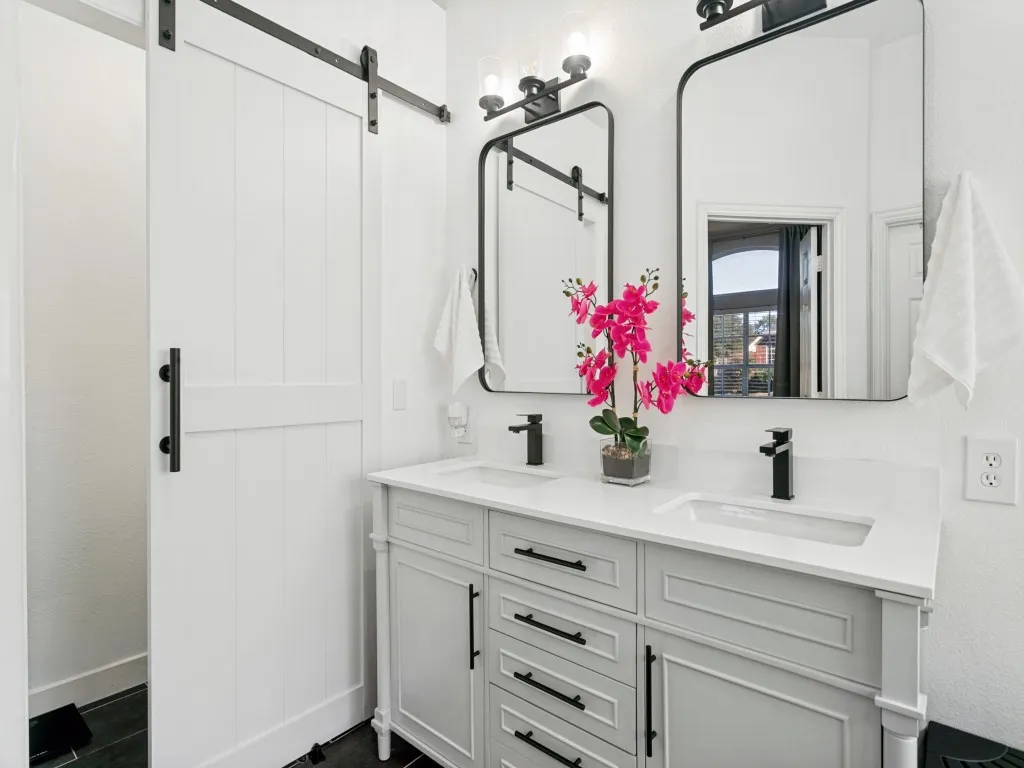 Dual vanity with integrated sinks, white countertop, and matte black fixtures