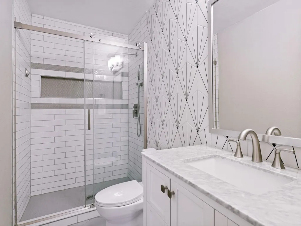 Glass-enclosed shower with subway tile, built-in niche, and mosaic accent
