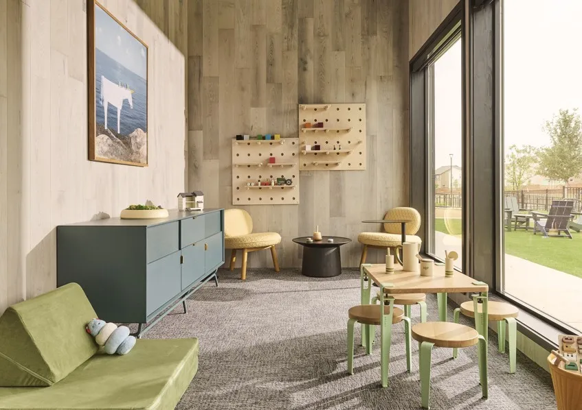 Living area with carpet flooring and wooden walls