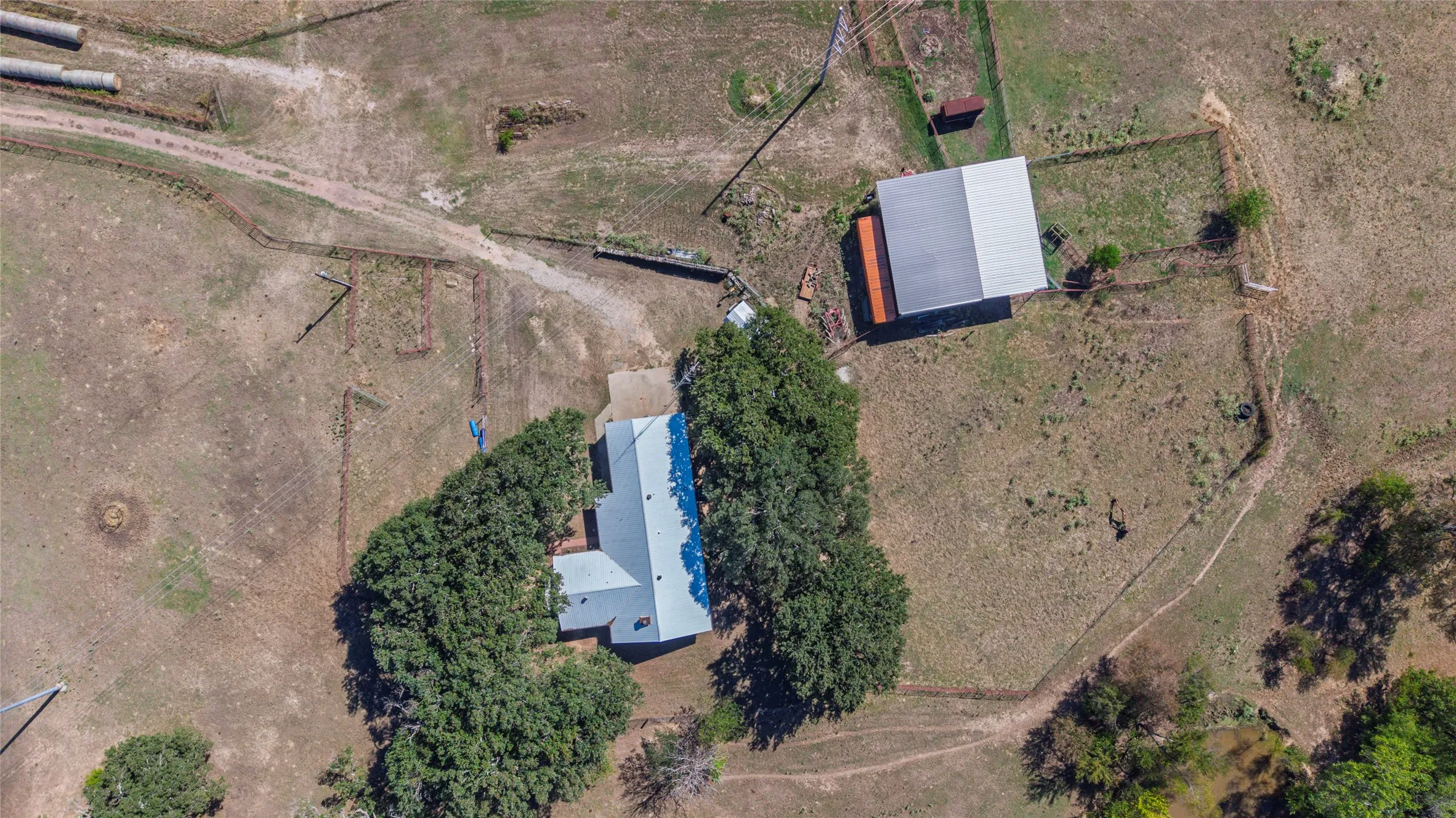 House is close to barn for hay or cattle sorting.