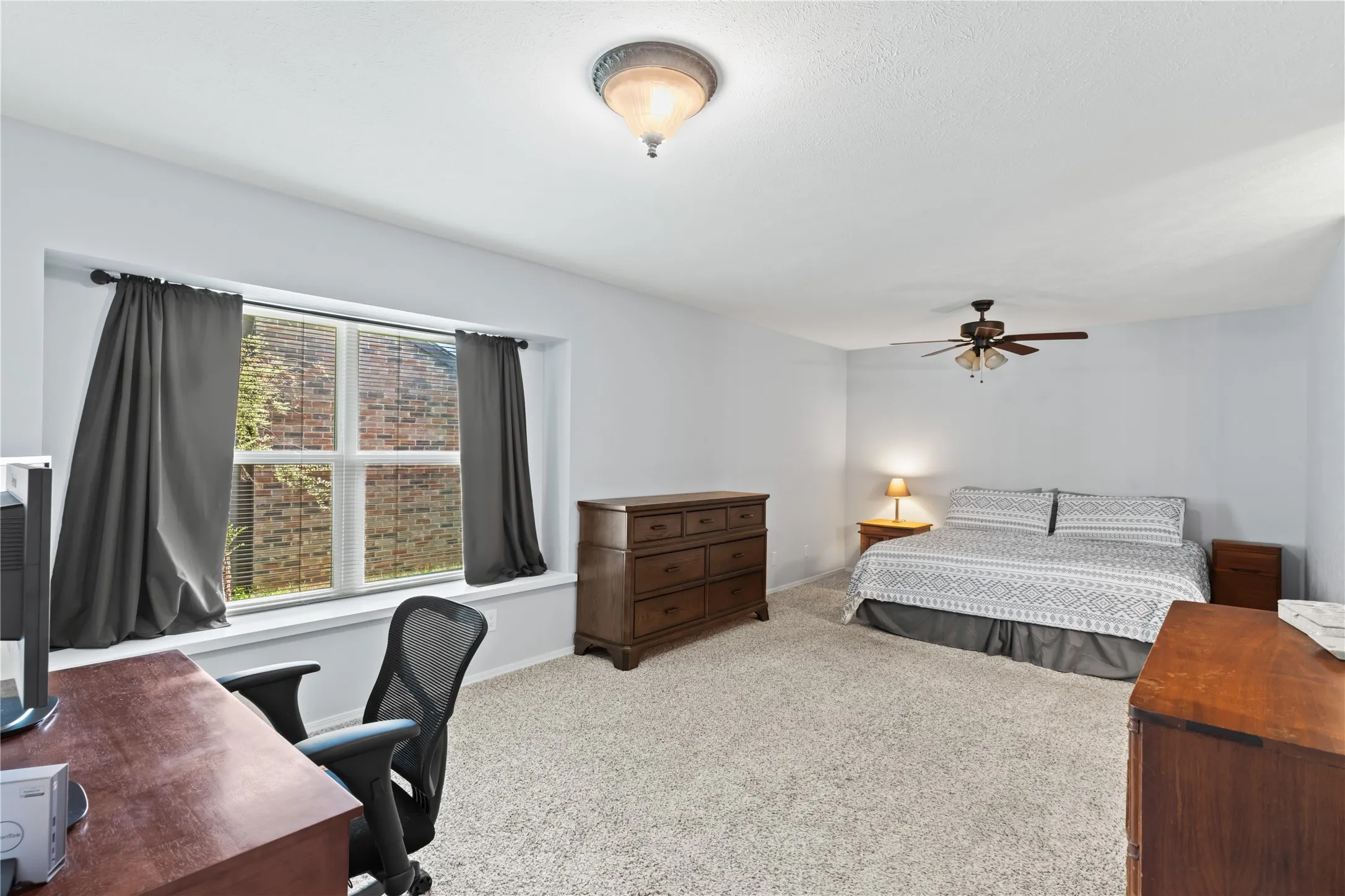 Primary bedroom has room for sitting area or desk