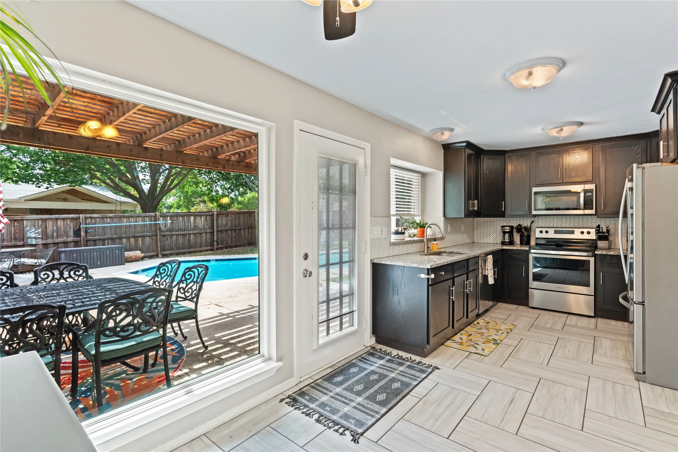 Updated kitchen with views of the yard and pool