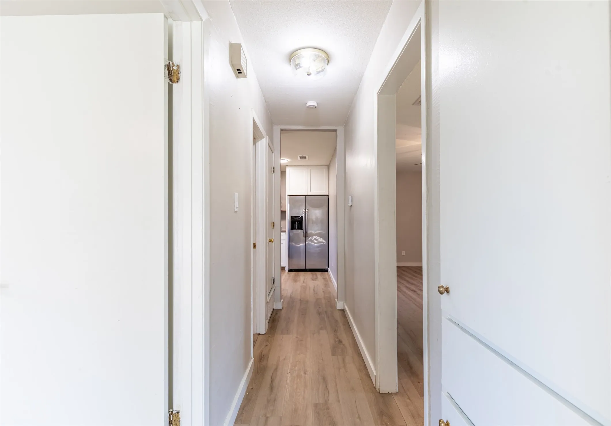 Hallway with linen storage.