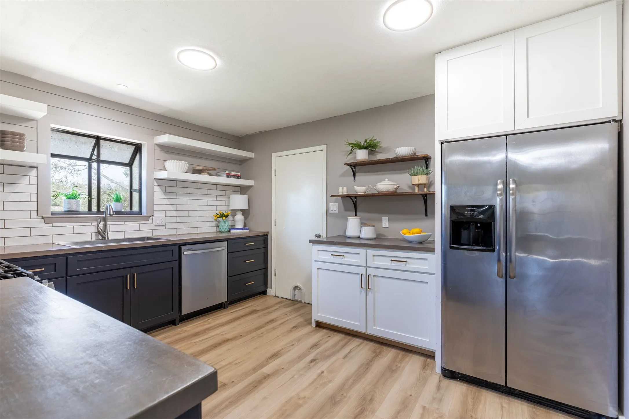 Fully remodeled kitchen with white and black cabinetry.