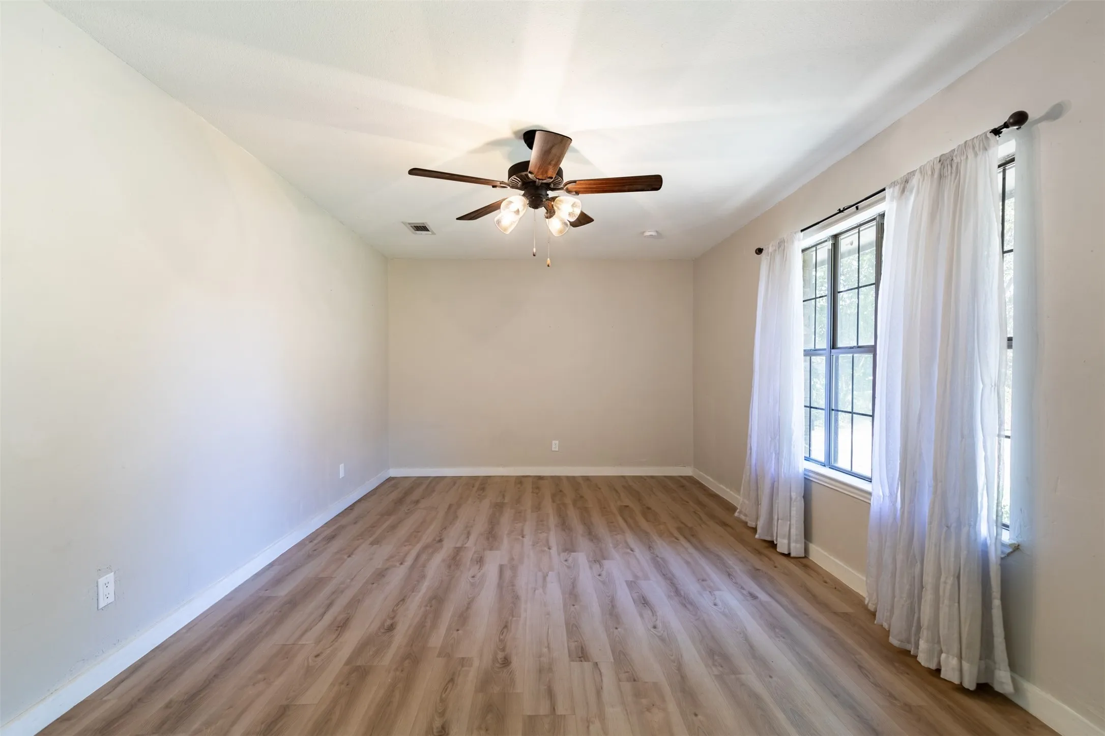 Living room with luxury vinyl plank flooring and natural light.