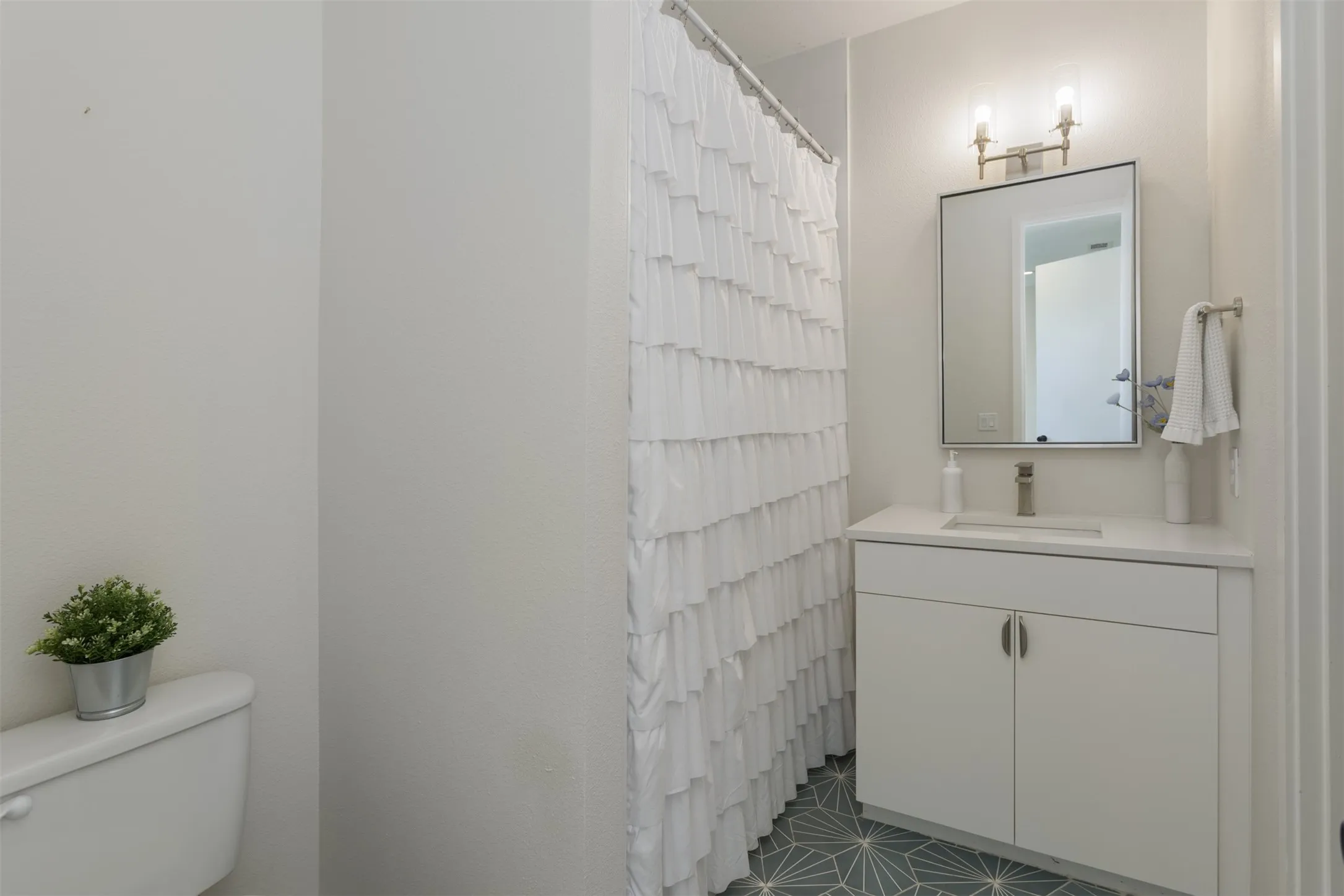 Full bath with vanity and curtained shower