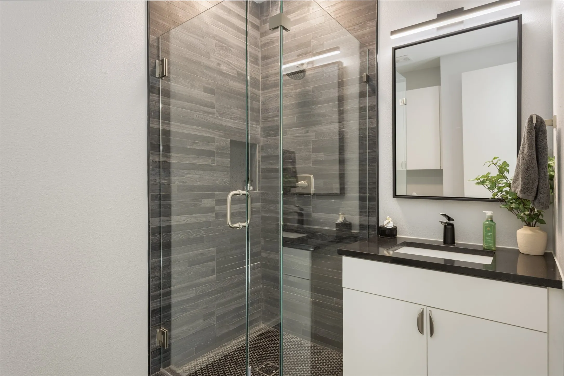 Full bathroom with vanity and a stall shower
