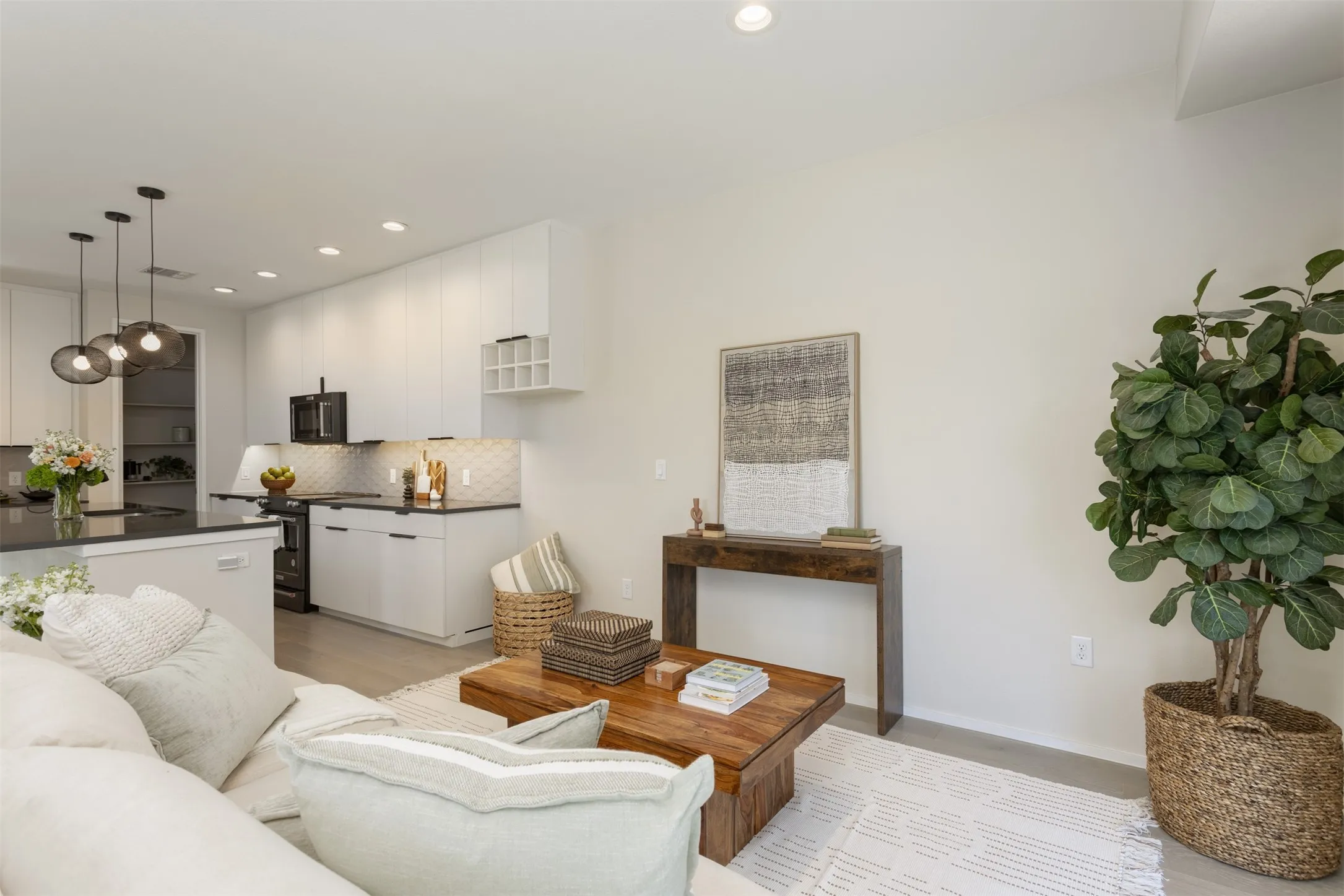 Living area featuring baseboards and recessed lighting