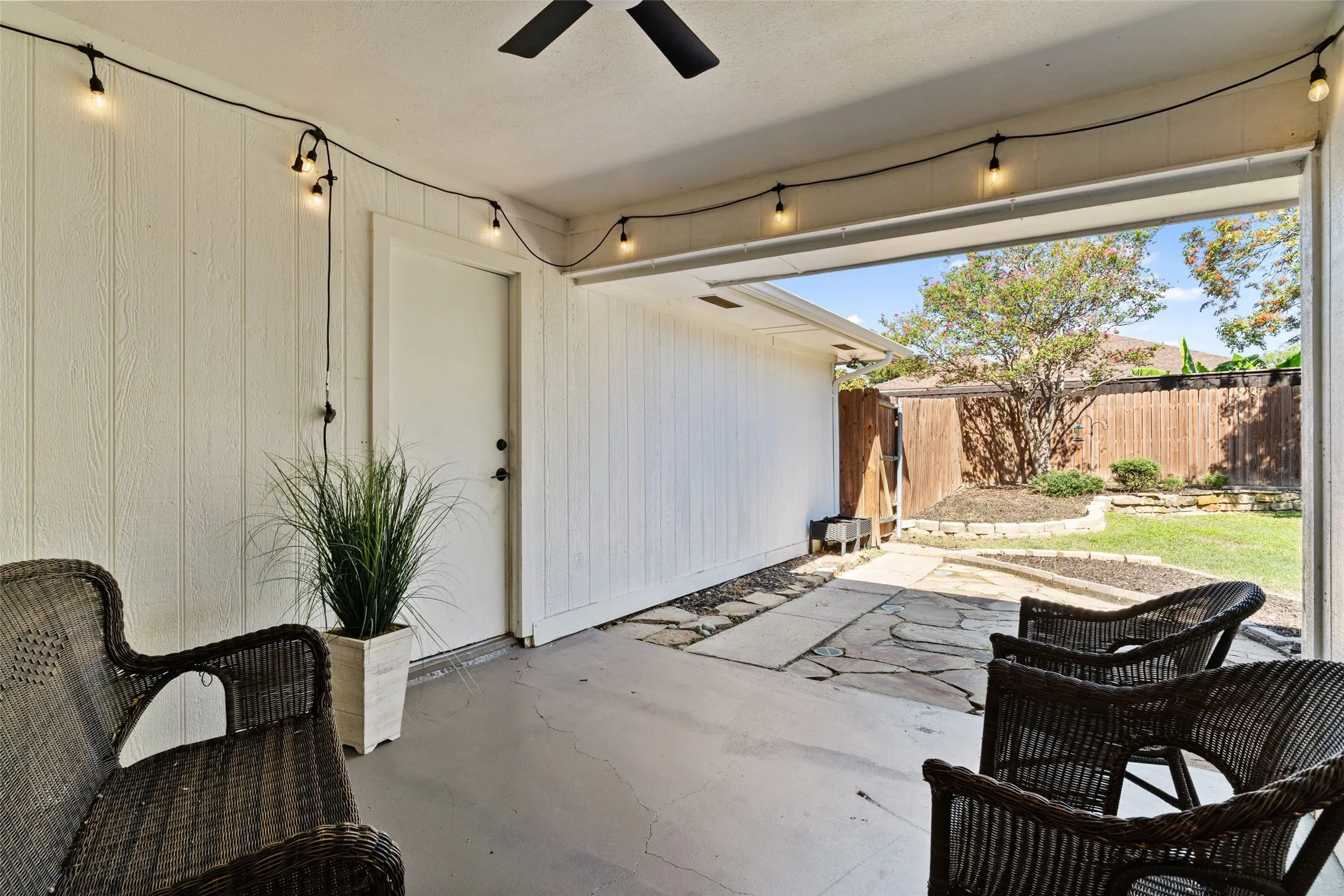Covered patio with concrete flooring, string lighting, and direct access to the backyard