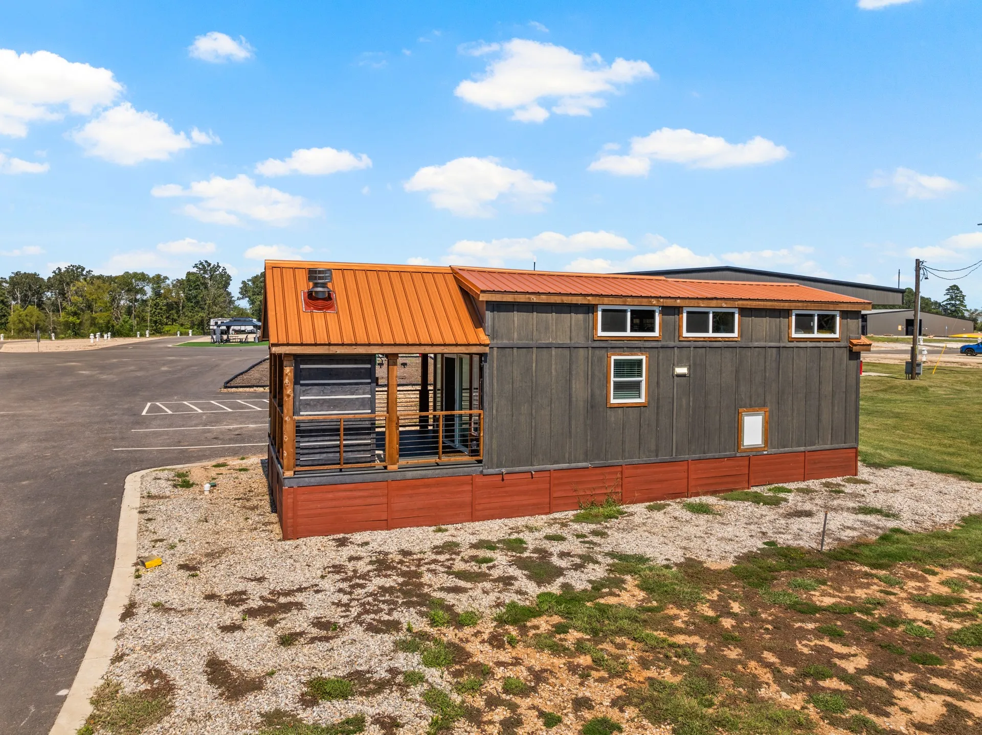 View of home's exterior featuring a metal roof and uncovered parking