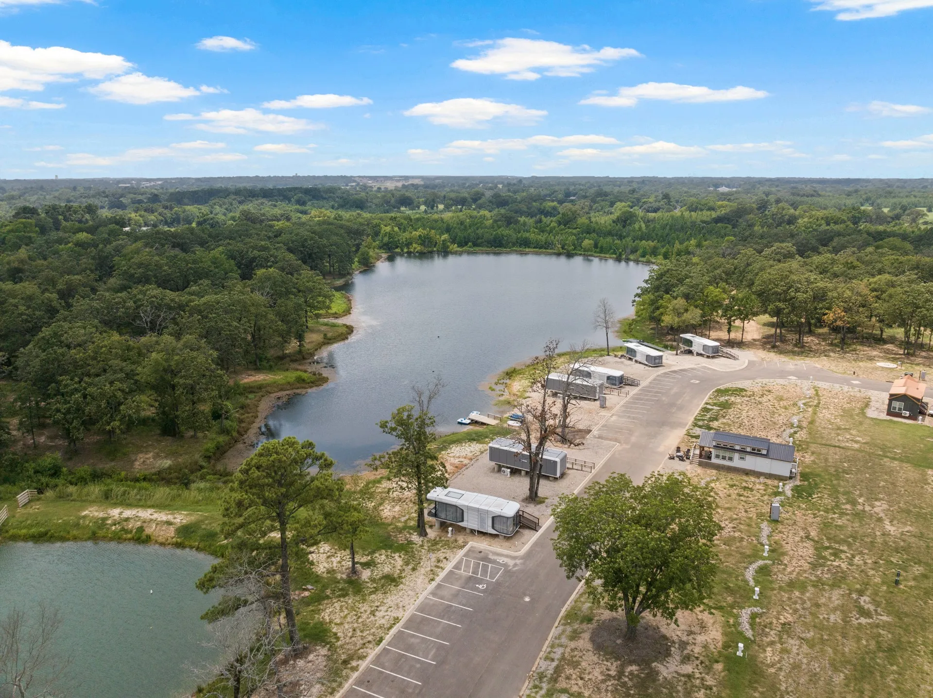 Bird's eye view of a nearby body of water and a forest