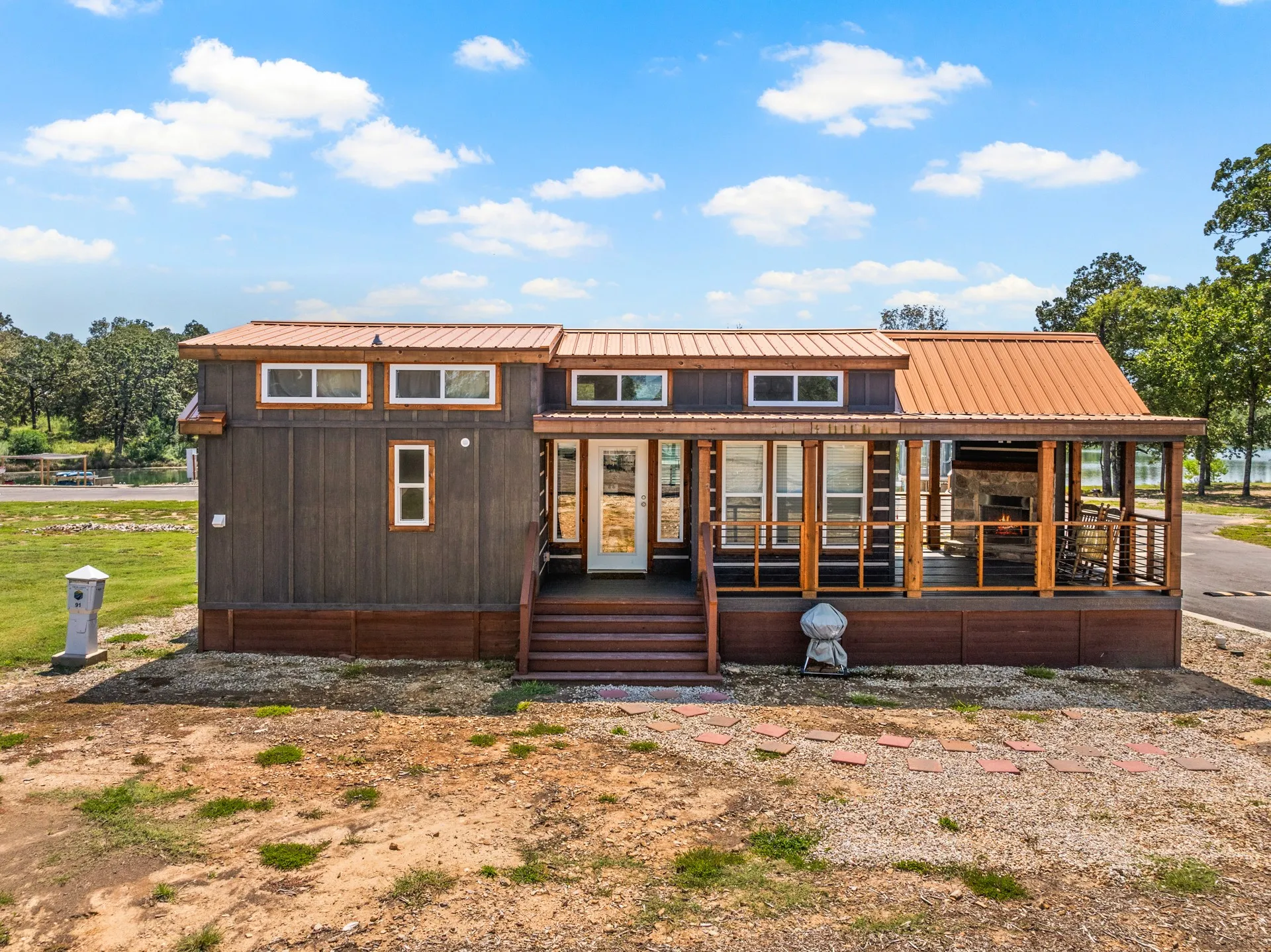 Rear view of property featuring a metal roof and a porch