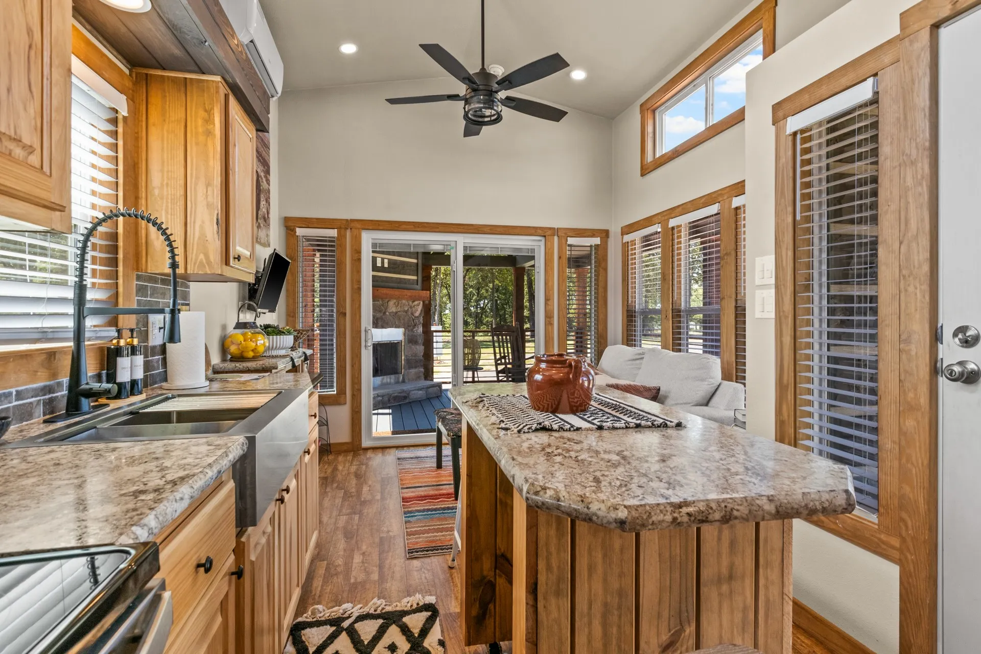 Kitchen featuring dark wood-style floors, open floor plan, a high ceiling, stainless steel range with electric stovetop, and a center island