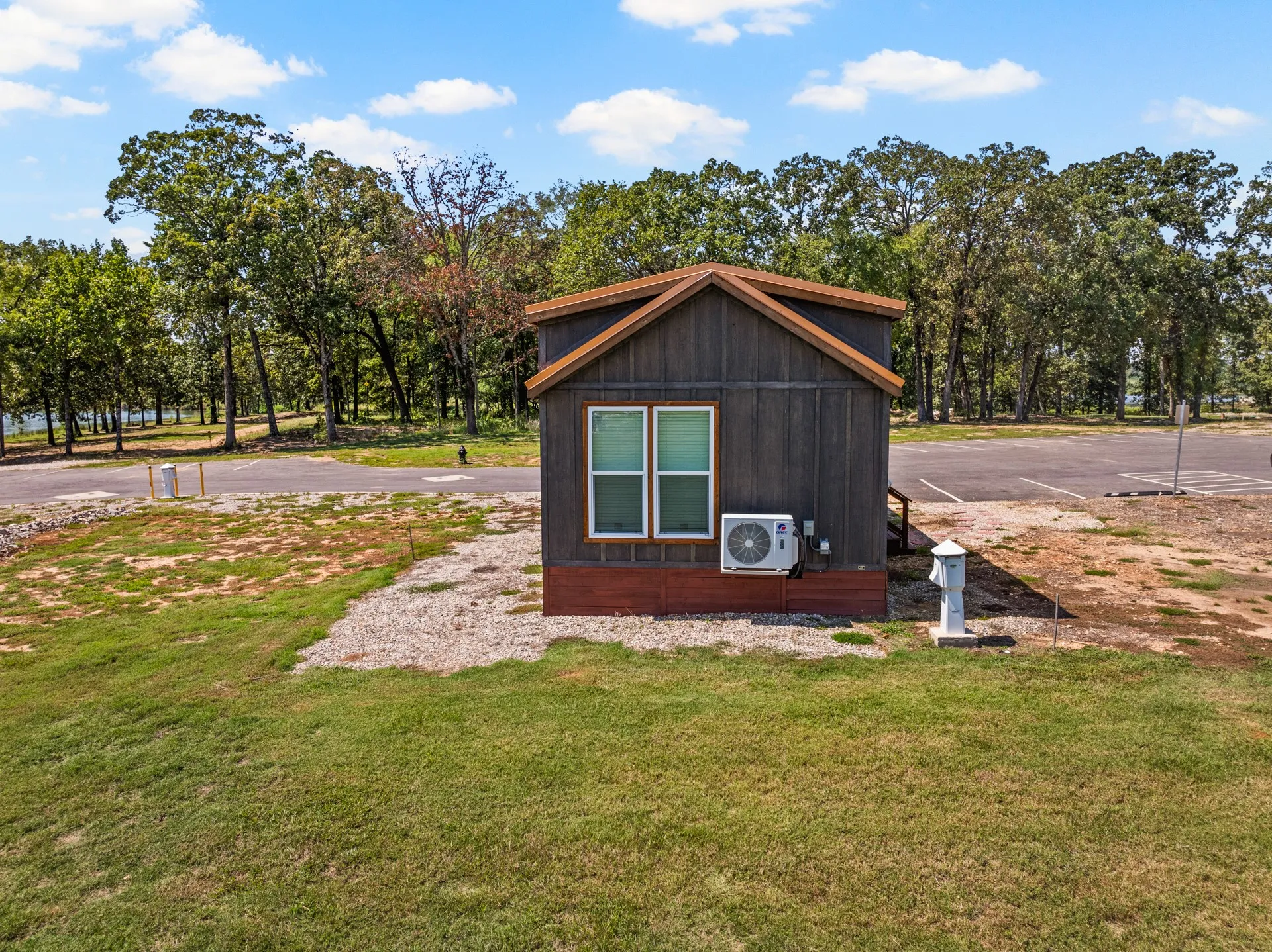 View of outbuilding with uncovered parking