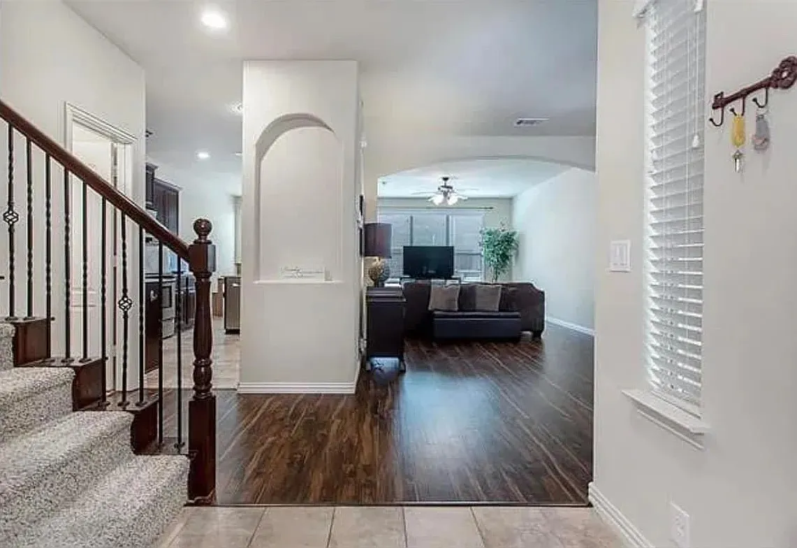 Tiled entryway featuring ceiling fan