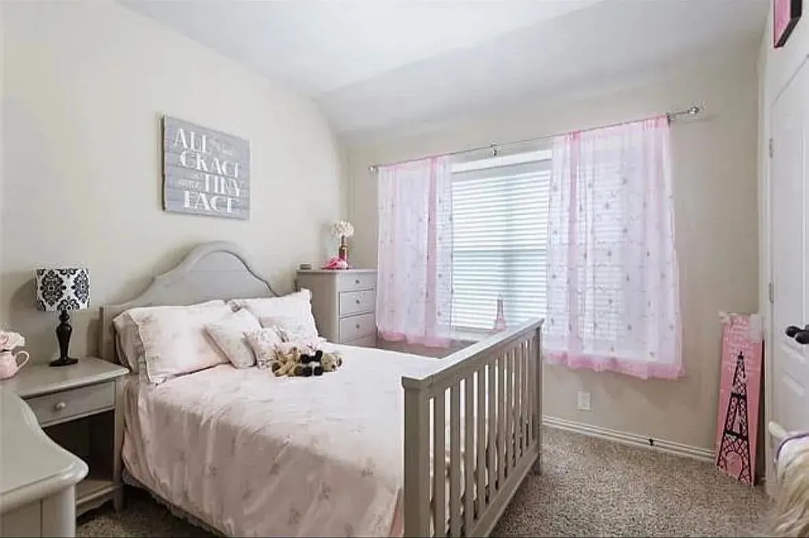 Carpeted bedroom featuring vaulted ceiling