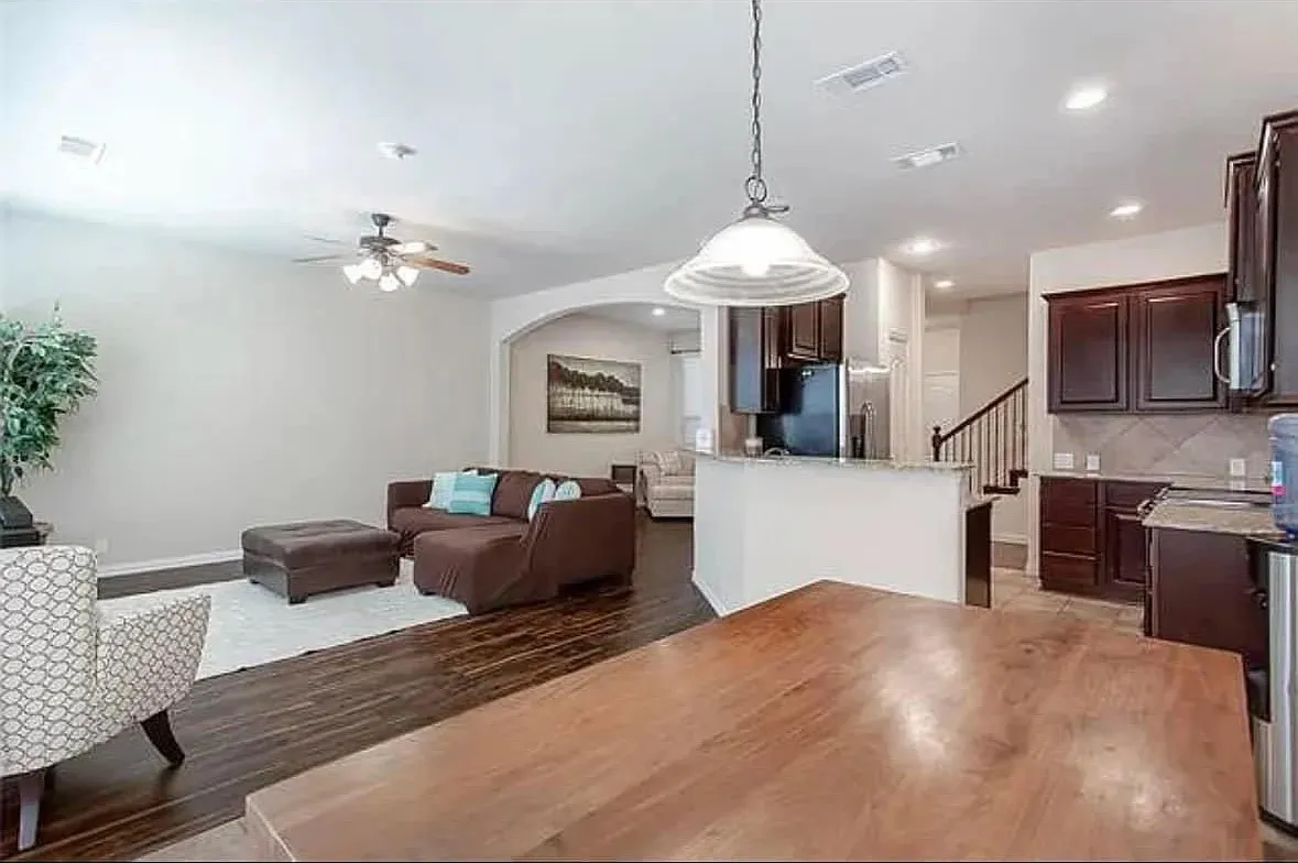 Living room featuring ceiling fan and hardwood / wood-style flooring