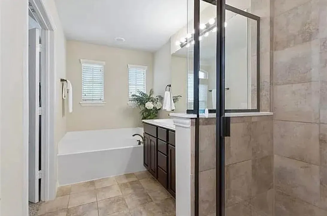 Bathroom featuring vanity and plus walk in shower
