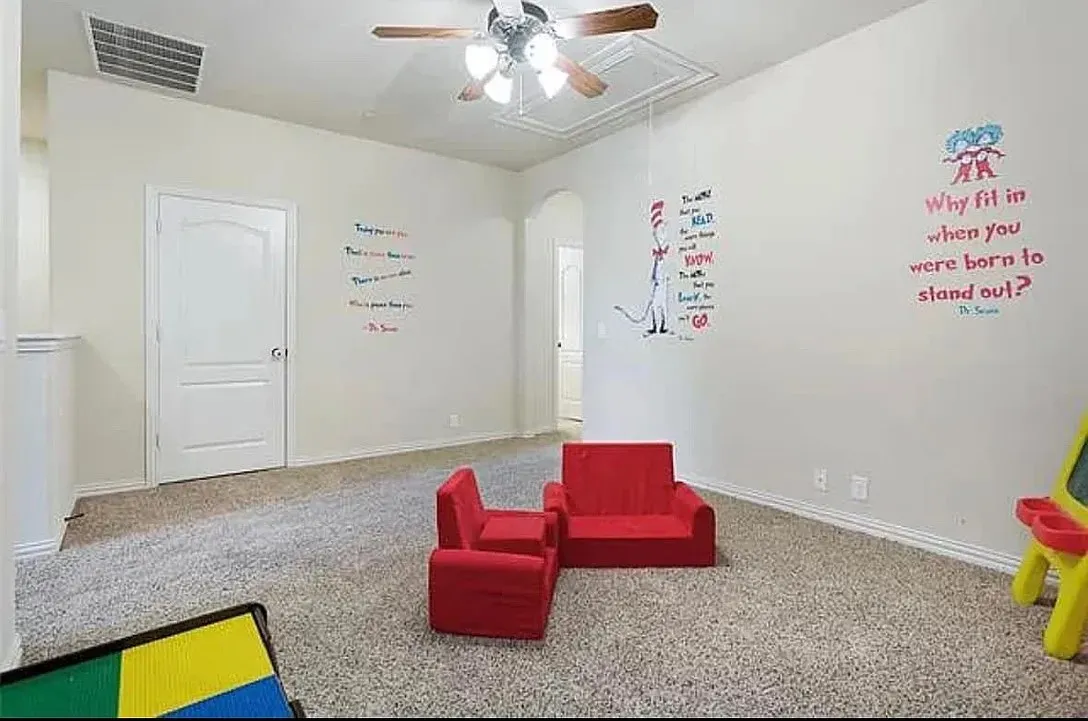 Game room with ceiling fan and carpet flooring