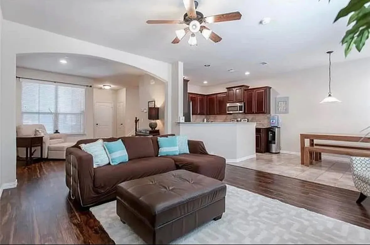 Living room with ceiling fan and light hardwood / wood-style flooring