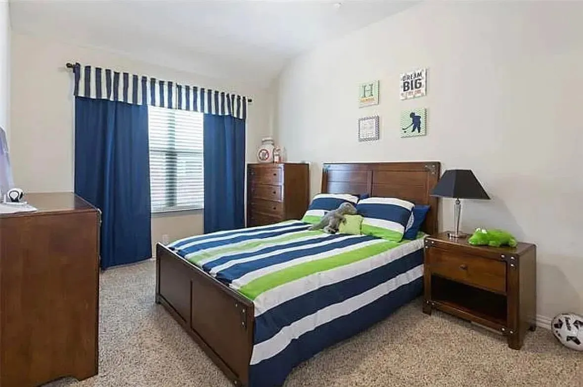 Carpeted bedroom with lofted ceiling