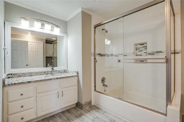 Updated bath with new granite vanity, and new floor.