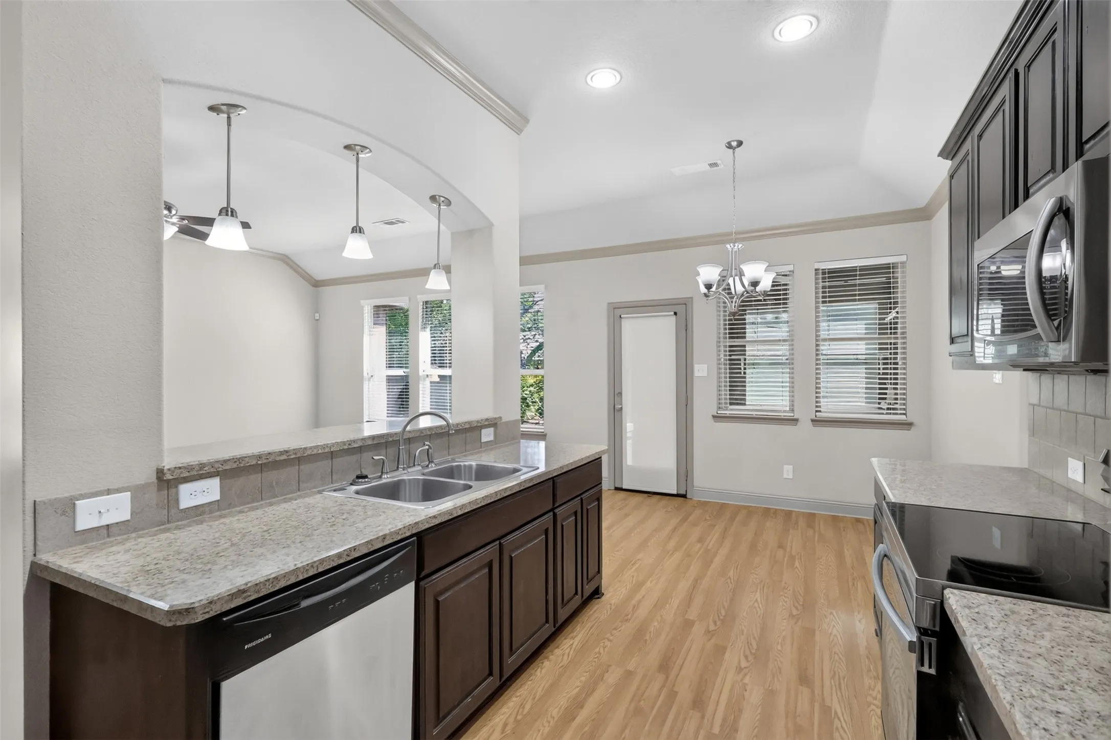 ANOTHER VIEW OF THE KITCHEN OPEN TO THE BREAKFAST AREA