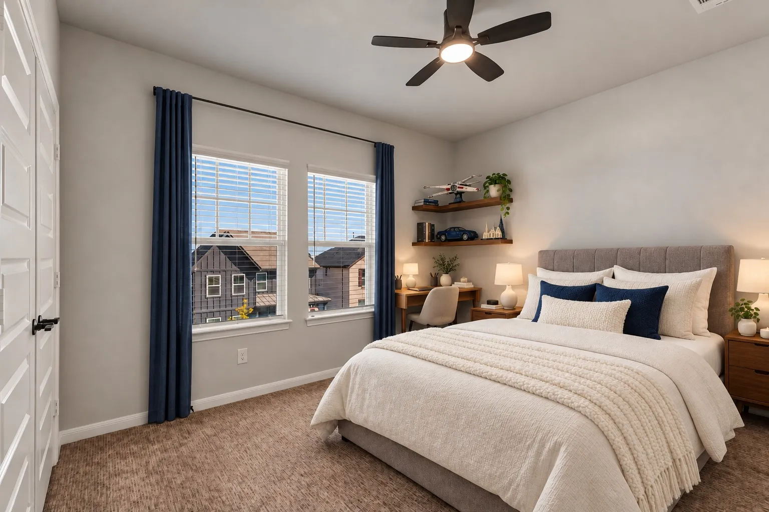 Dual windows with blinds, a ceiling fan with integrated lighting, and carpeted flooring