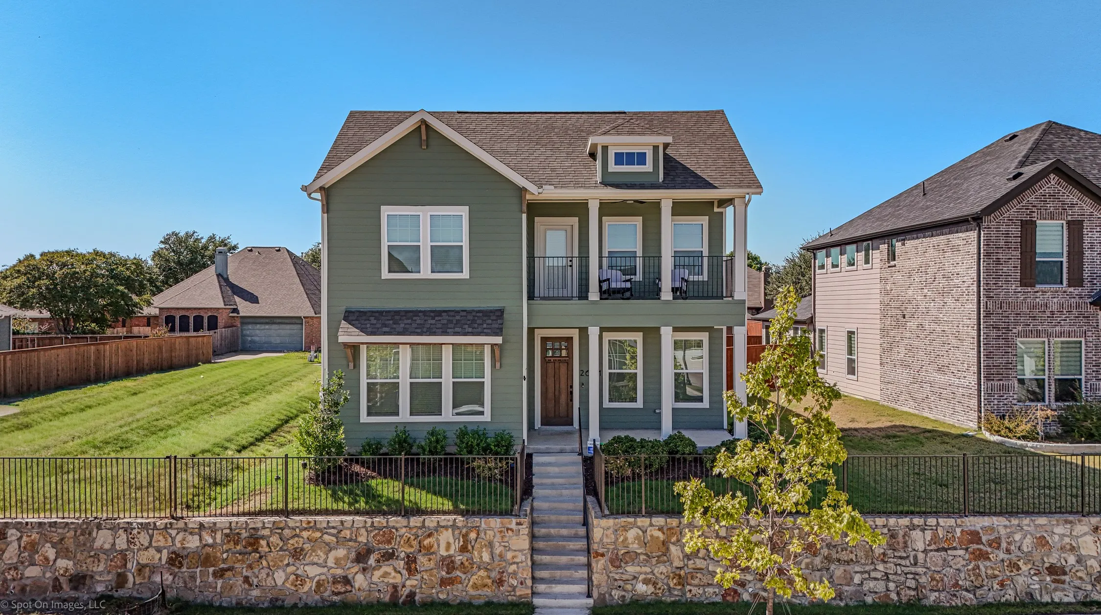 Two-story residence with green siding and white trim