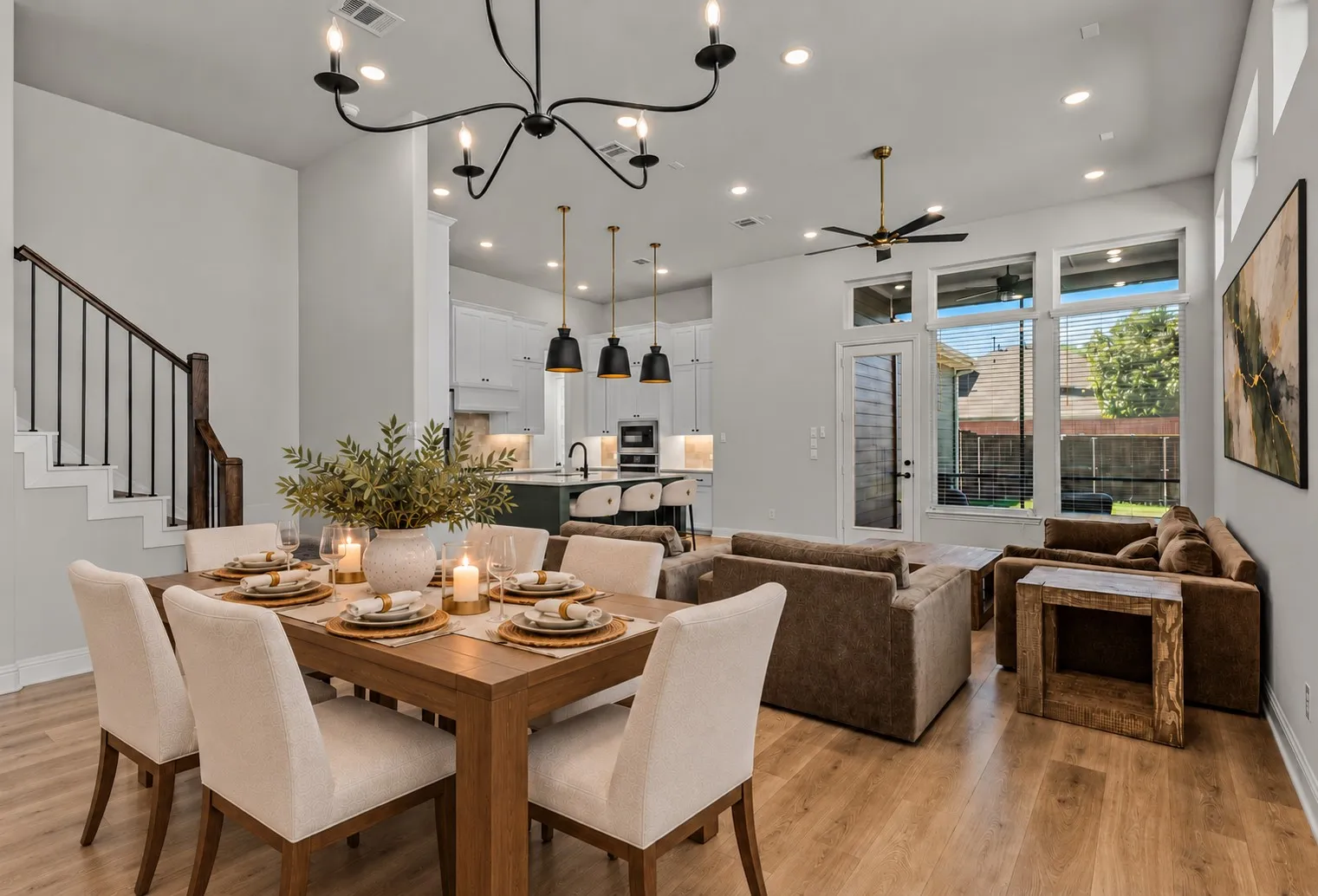 Wood-finish flooring throughout, complemented by a modern chandelier and recessed lighting