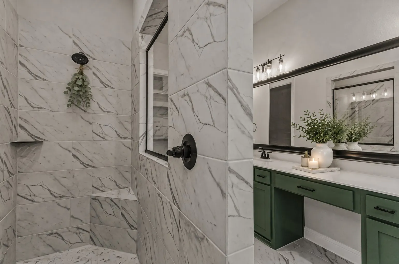 Curbless shower with marble-look tile, built-in shower bench, and matte black fixtures