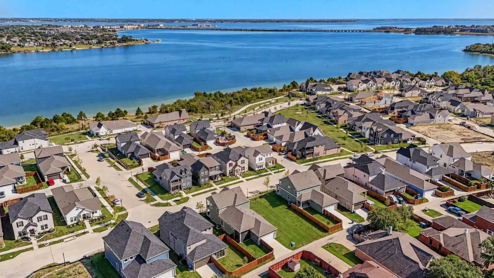 Waterside community featuring a variety of architectural styles, paved streets, and landscaped lots