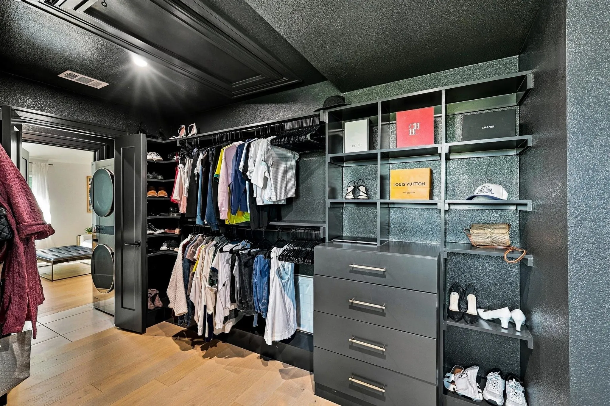 Custom closet system featuring built-in shelving, hanging rods, and integrated drawers
