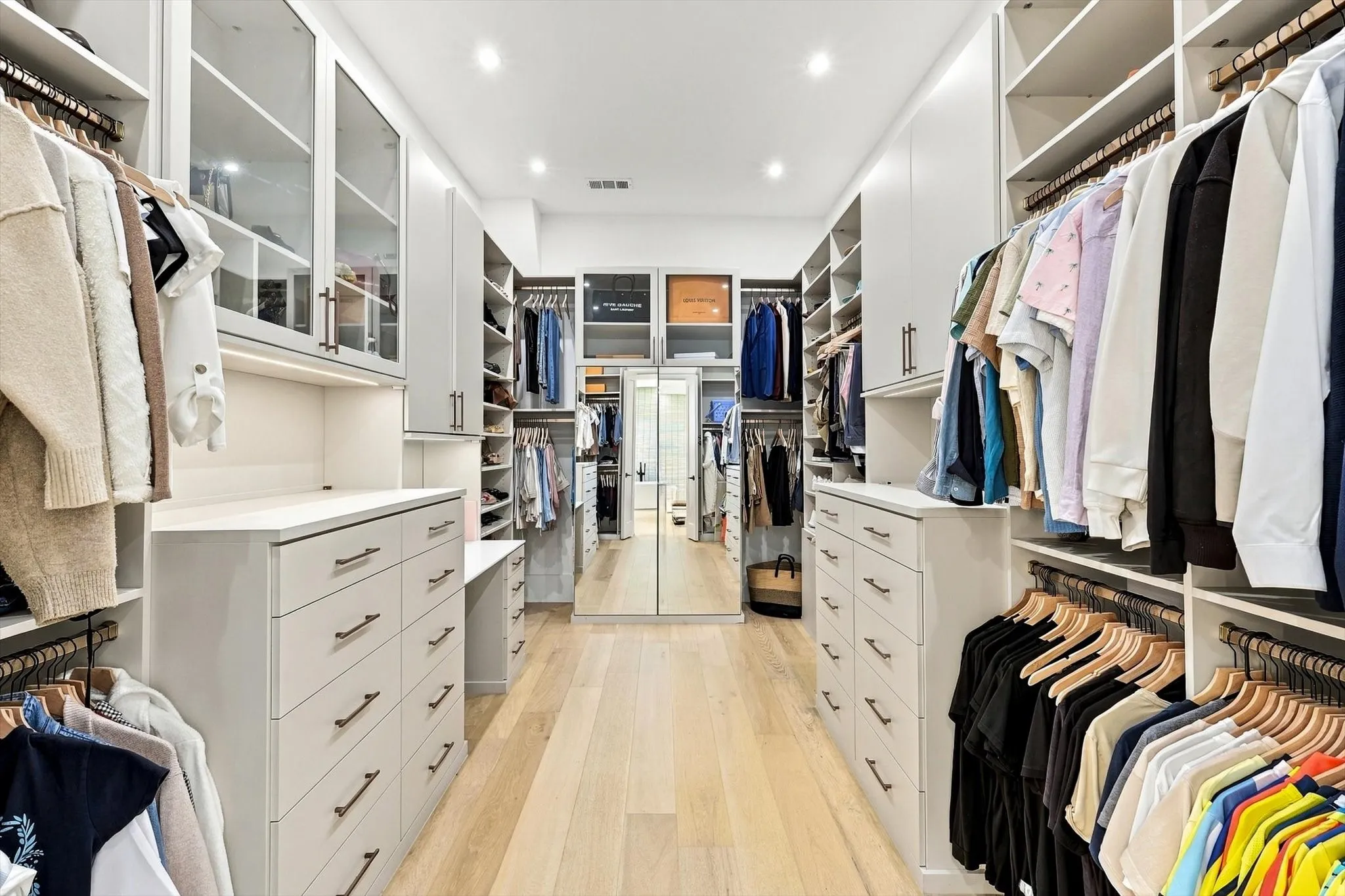 Custom built-in closet system with extensive shelving, drawer storage, and hanging rods