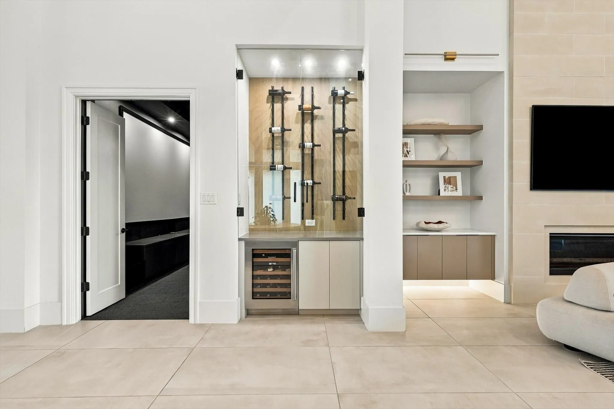 Built-in wine storage with glass enclosure, integrated wine refrigerator, and recessed lighting